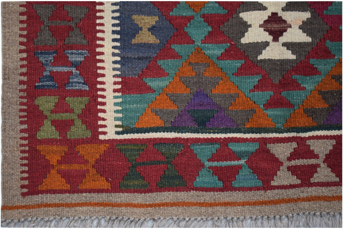 Handwoven Afghan Maimana kilim featuring a geometric pattern in vibrant wool colors.
