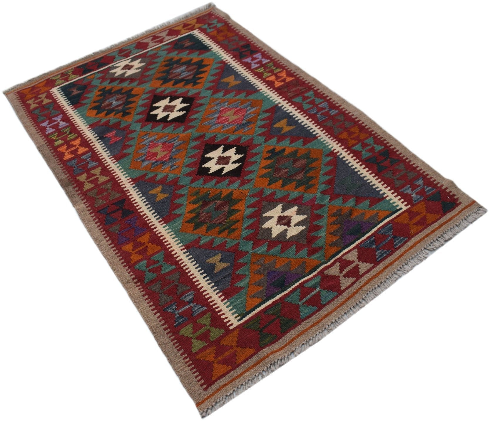 A rectangular Afghan Maimana kilim rug featuring a geometric pattern in rich, multicolored wool.