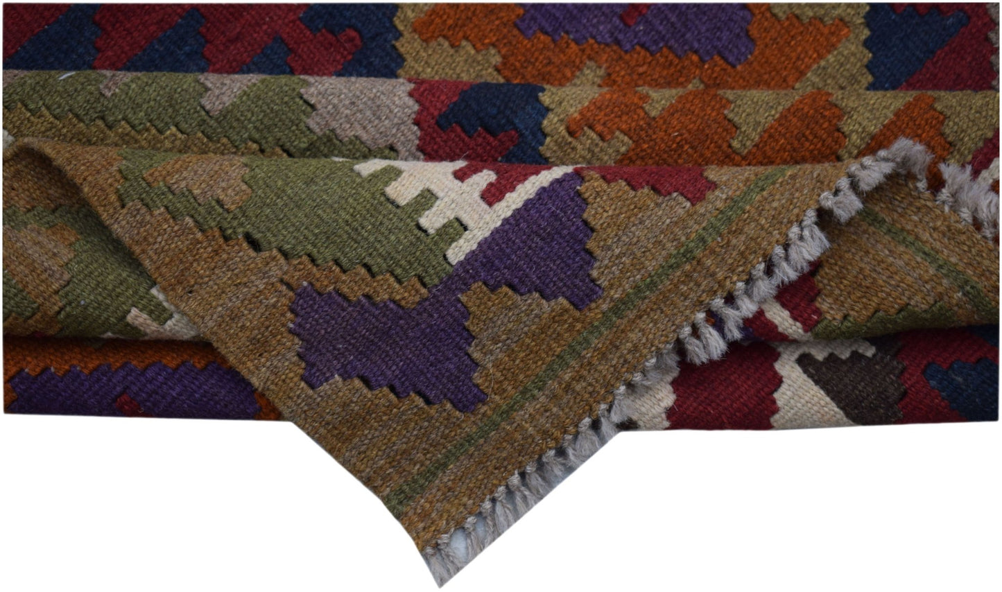 A handwoven Afghan Maimana kilim rug featuring a colorful geometric pattern and flatweave texture.