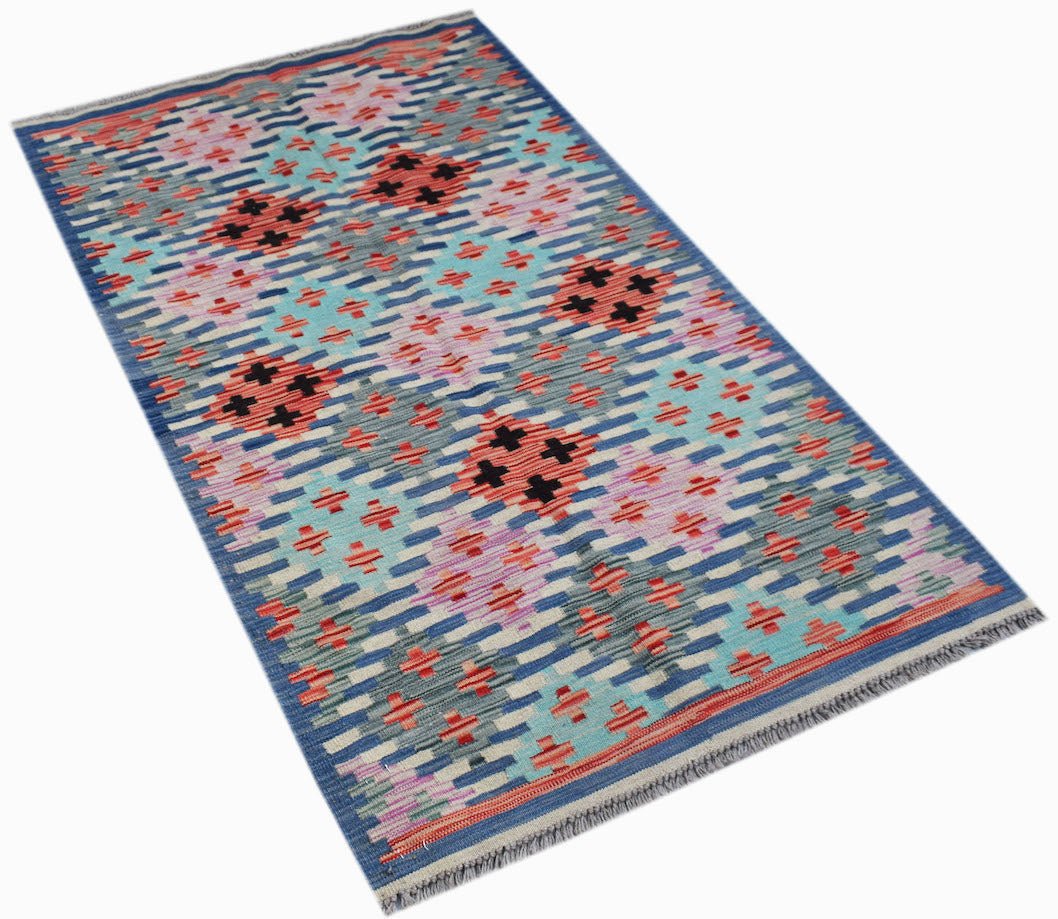 Handwoven Afghan Maimana kilim rug featuring a geometric pattern in blue, pink, and orange wool.