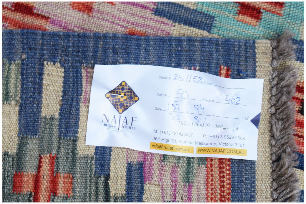 A handwoven Afghan Maimana Kilim rug featuring a colorful geometric pattern and flatweave texture.