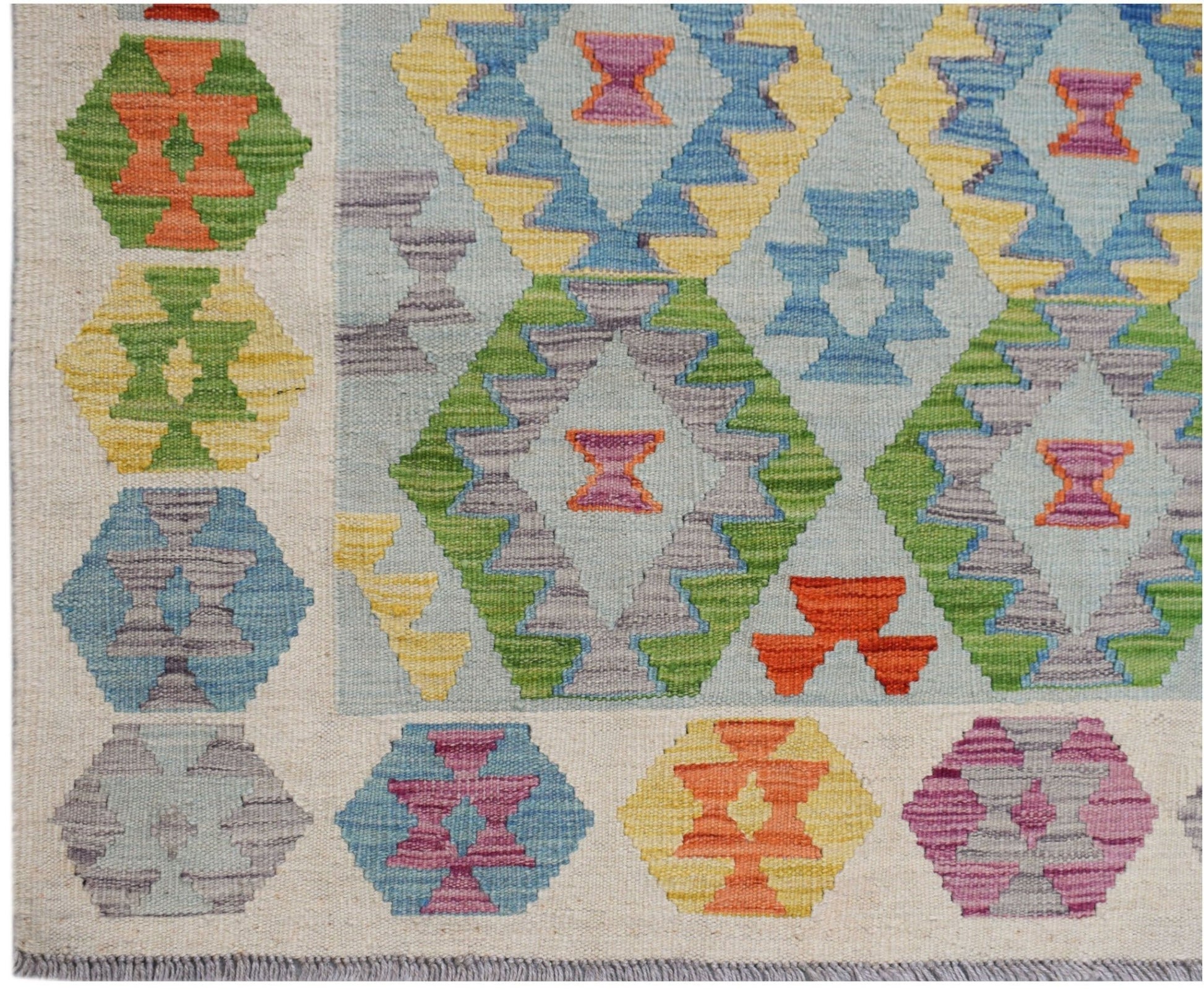 Handwoven Afghan Maimana kilim featuring a light blue field with colorful geometric diamond motifs.