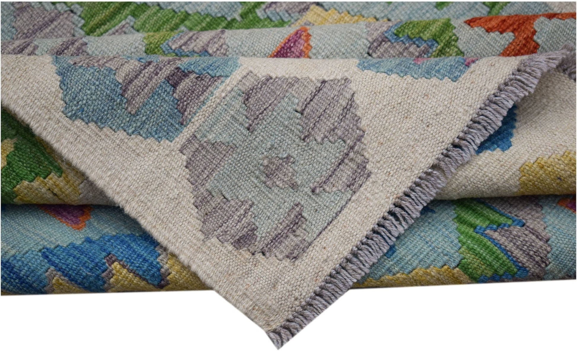 A handwoven Afghan Maimana kilim rug featuring a colorful geometric pattern on a wool base.
