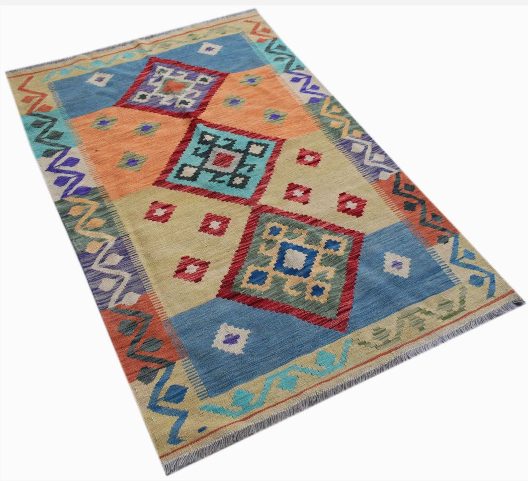 Handwoven Afghan Maimana kilim rug featuring a colorful geometric diamond pattern on wool.