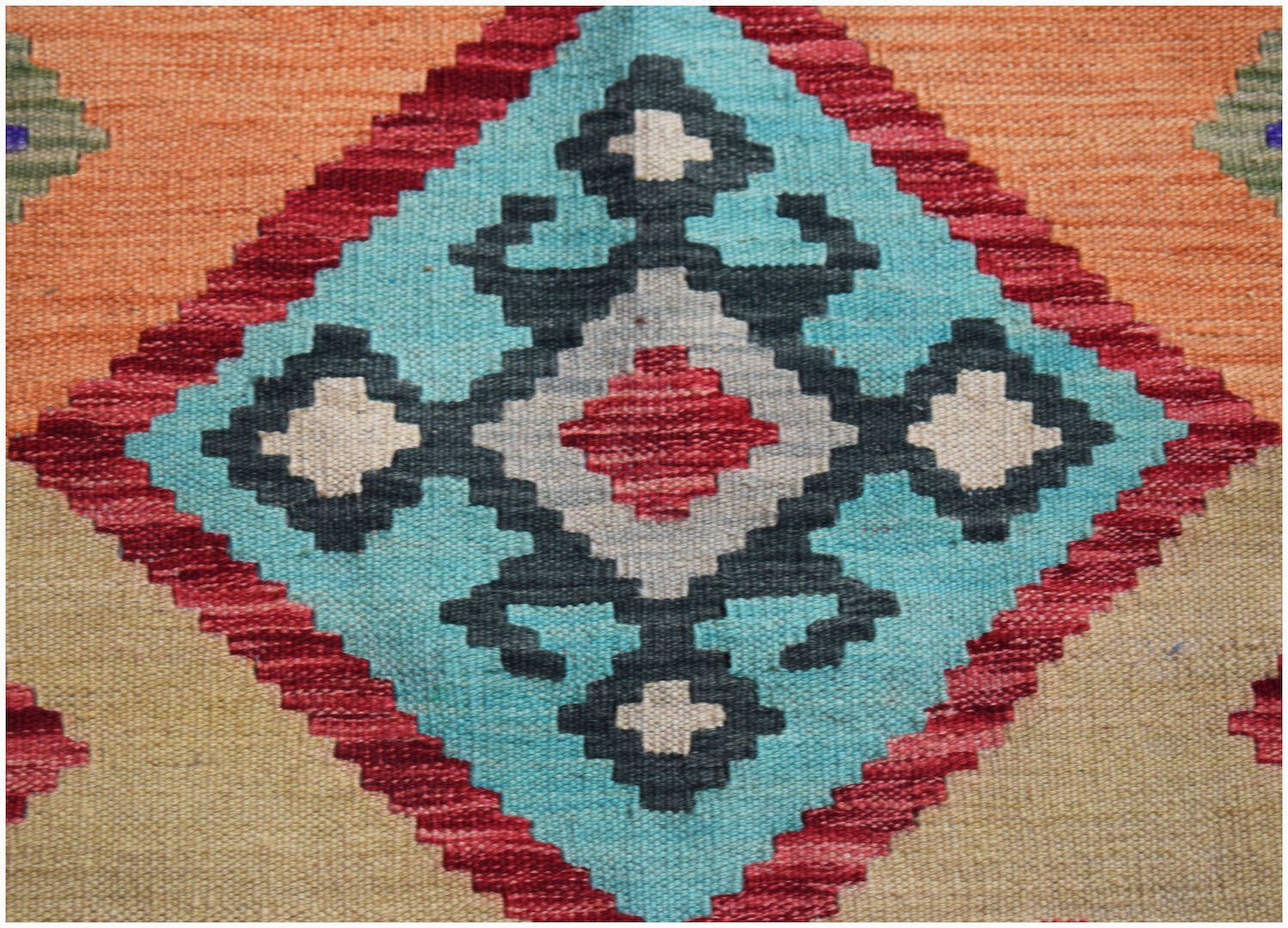 Handwoven Afghan Maimana kilim featuring a geometric diamond pattern in vibrant wool colors.