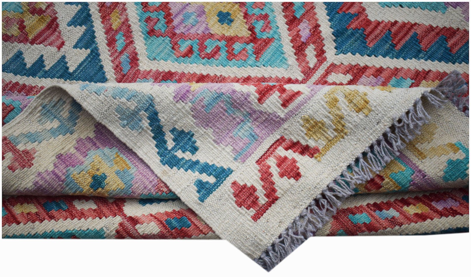 A handmade Afghan Maimana kilim rug featuring a colorful geometric pattern and flatweave texture.