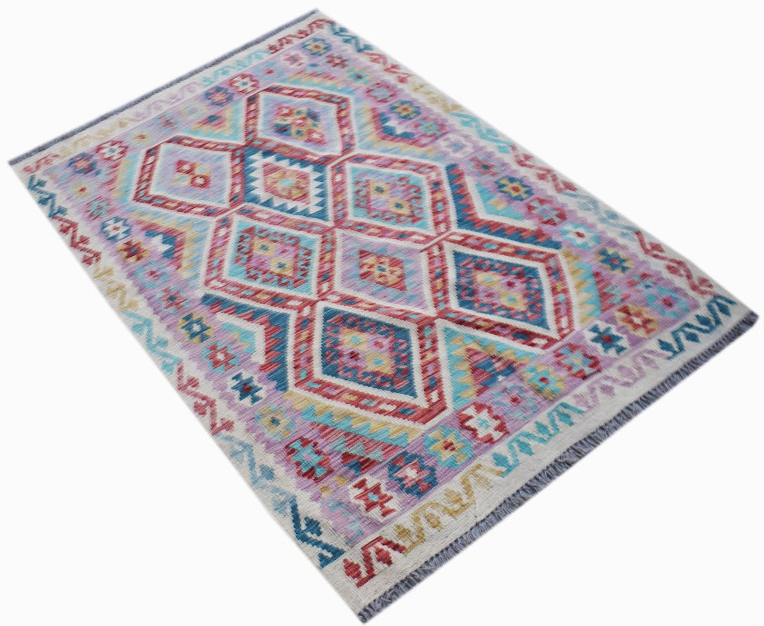 Handwoven Afghan Maimana kilim rug featuring a colorful geometric diamond pattern in wool.
