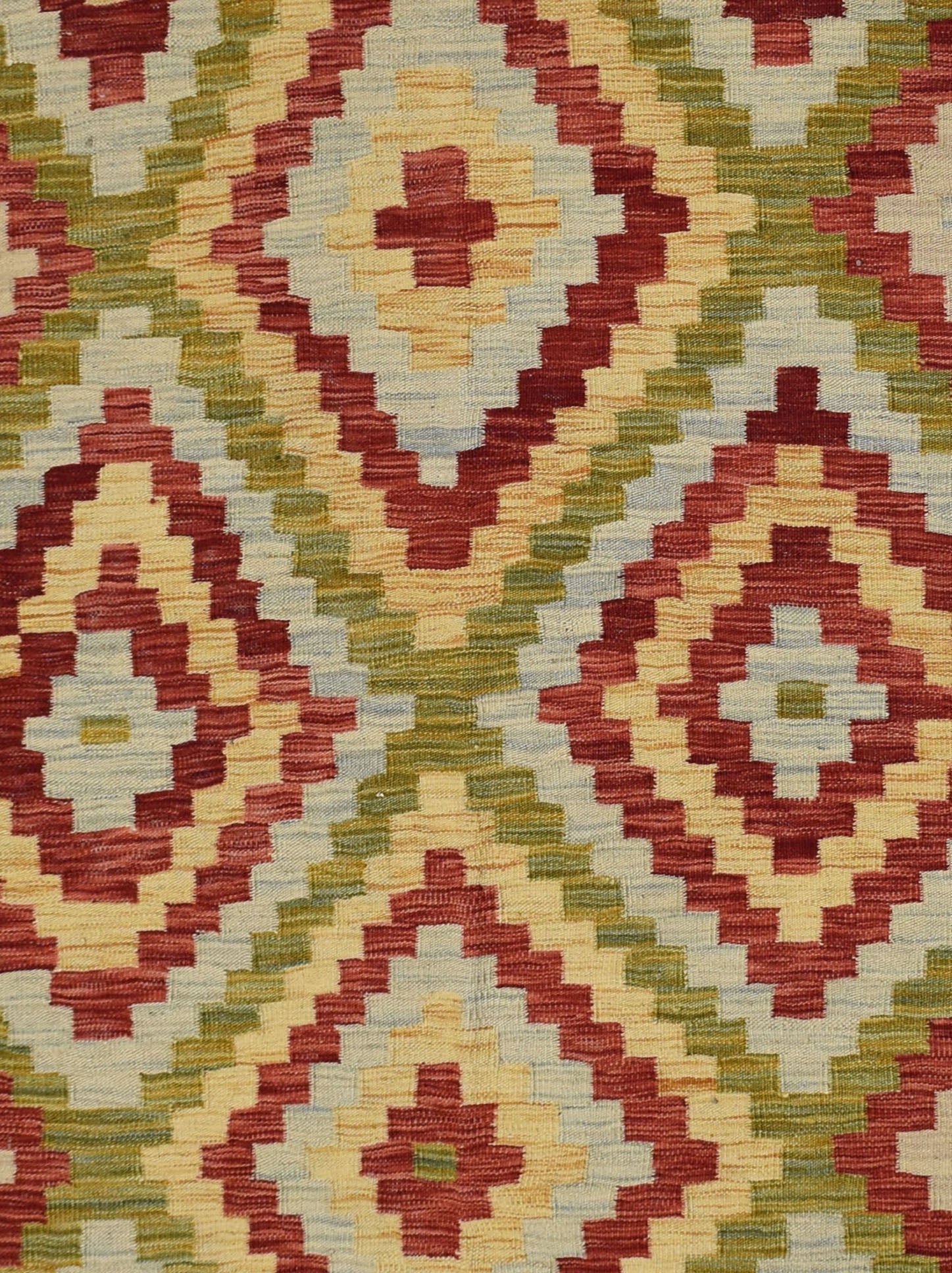 Handmade Afghan Maimana kilim rug featuring a geometric diamond pattern in red, green, and cream.