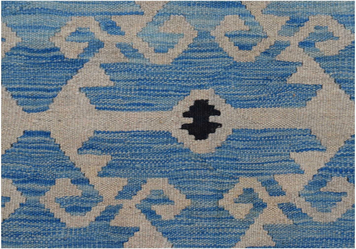 Handwoven Afghan Maimana kilim featuring a geometric cream pattern on a blue gradient background.