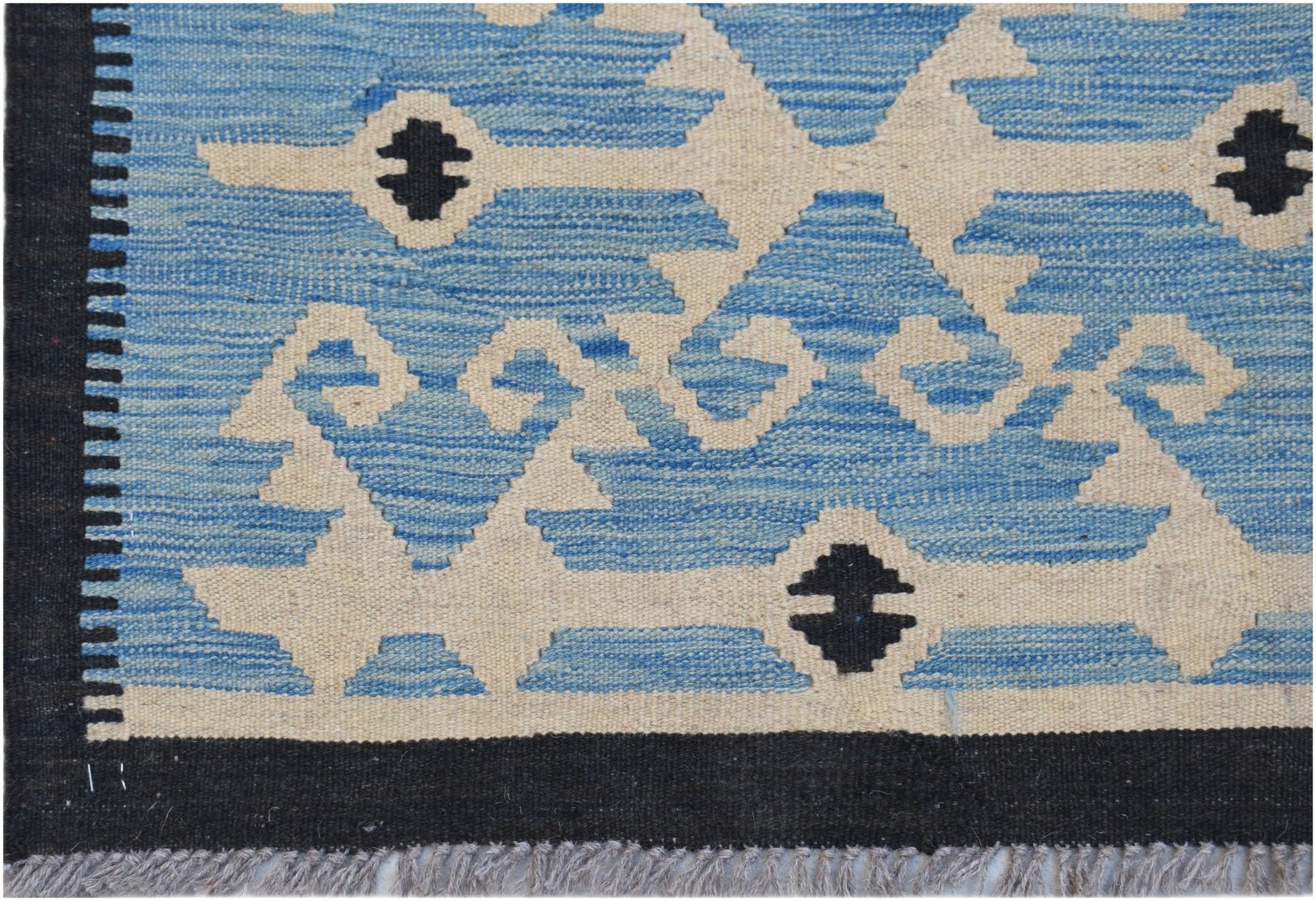 Handwoven Afghan Maimana kilim featuring a geometric pattern in blue, cream, and black.