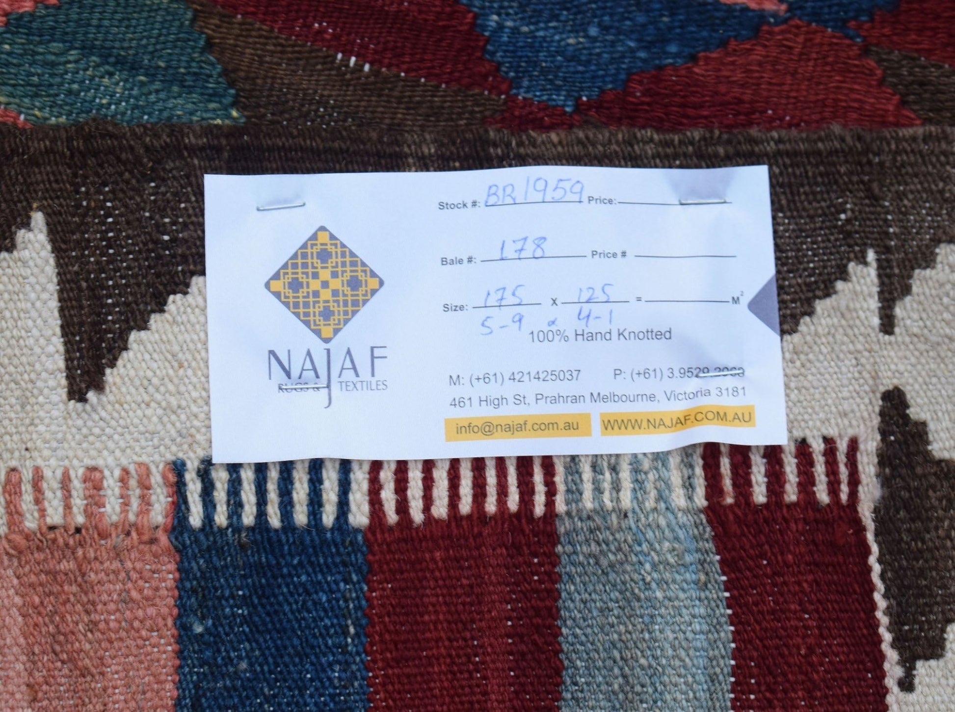 An Afghan Maimana Kilim rug featuring a flatweave texture and geometric patterns in rich colors.