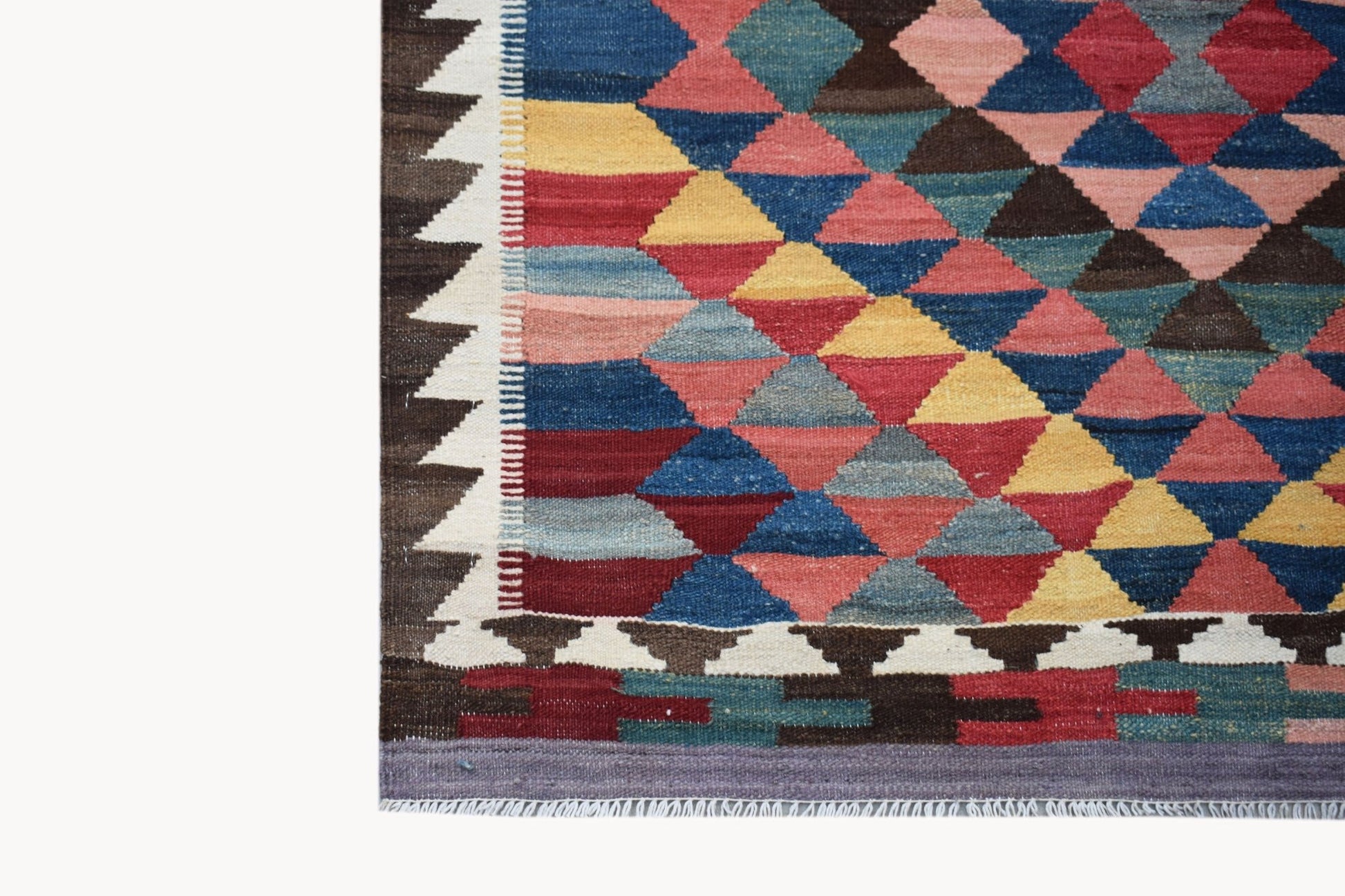 Handwoven Afghan Maimana kilim featuring a colorful geometric diamond pattern and fringed edges.
