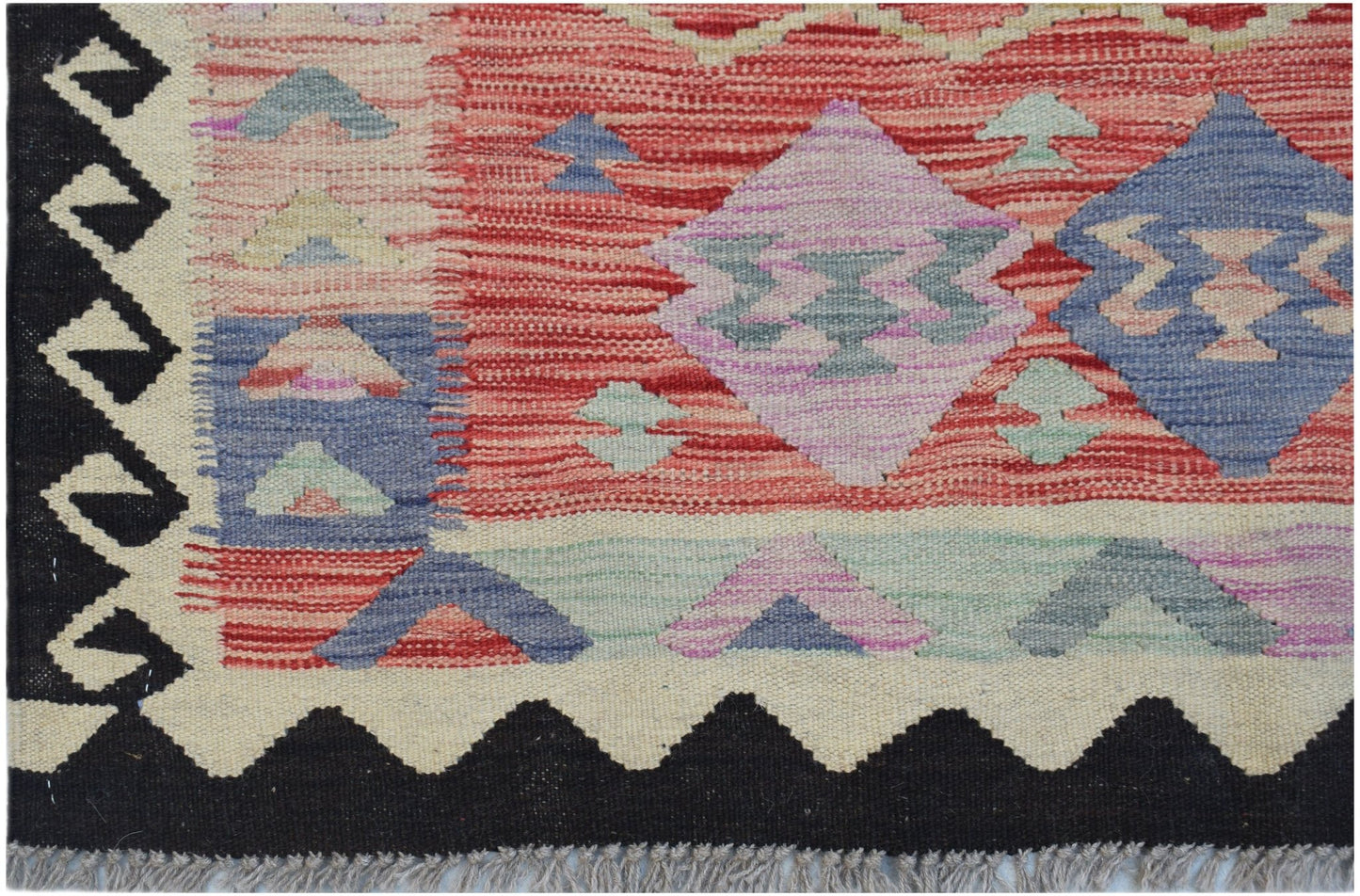 Handwoven Afghan Maimana kilim featuring geometric patterns in red, blue, and purple wool.