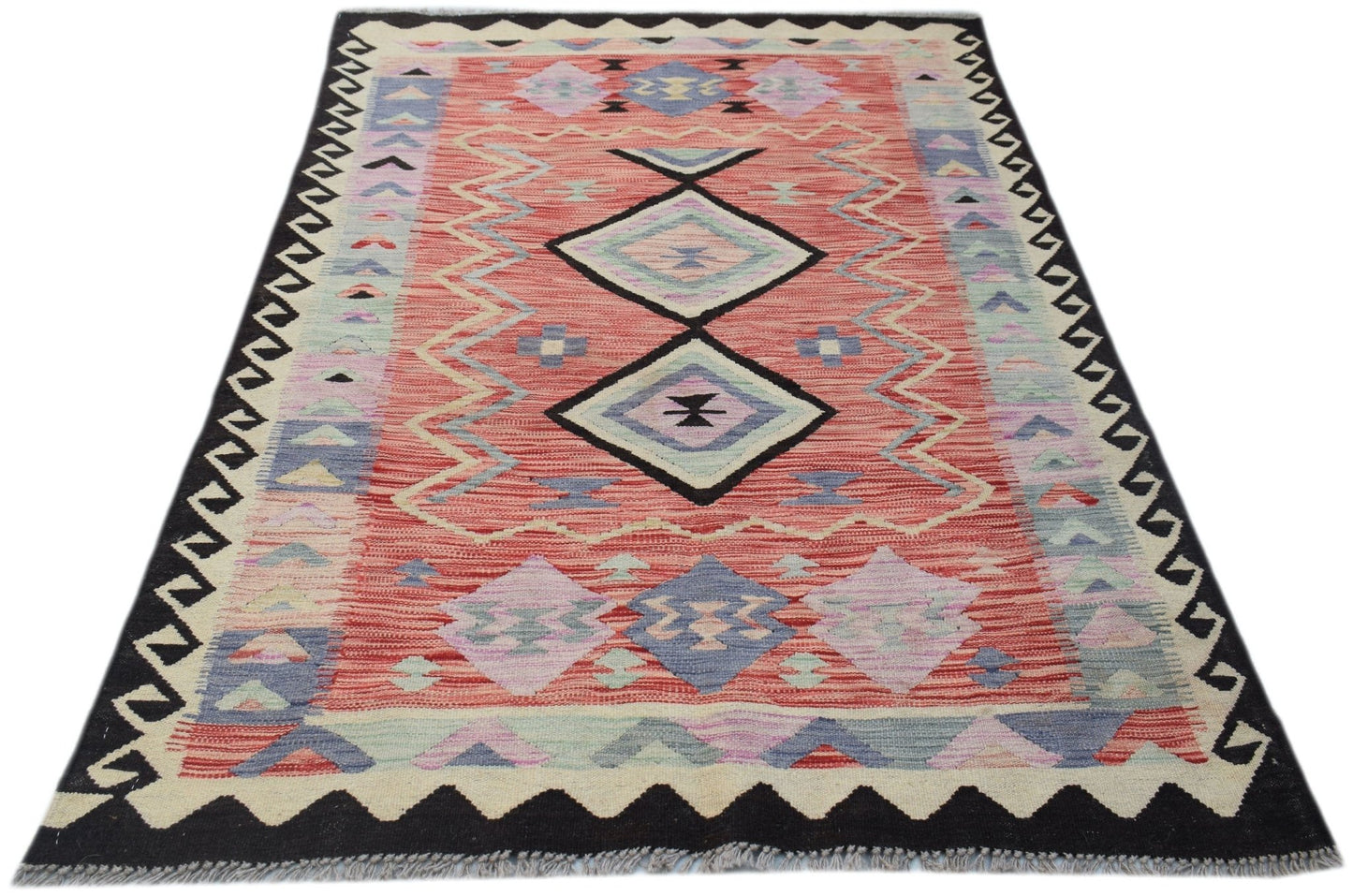Handwoven Afghan Maimana kilim rug featuring a geometric pattern in red, blue, and purple tones.