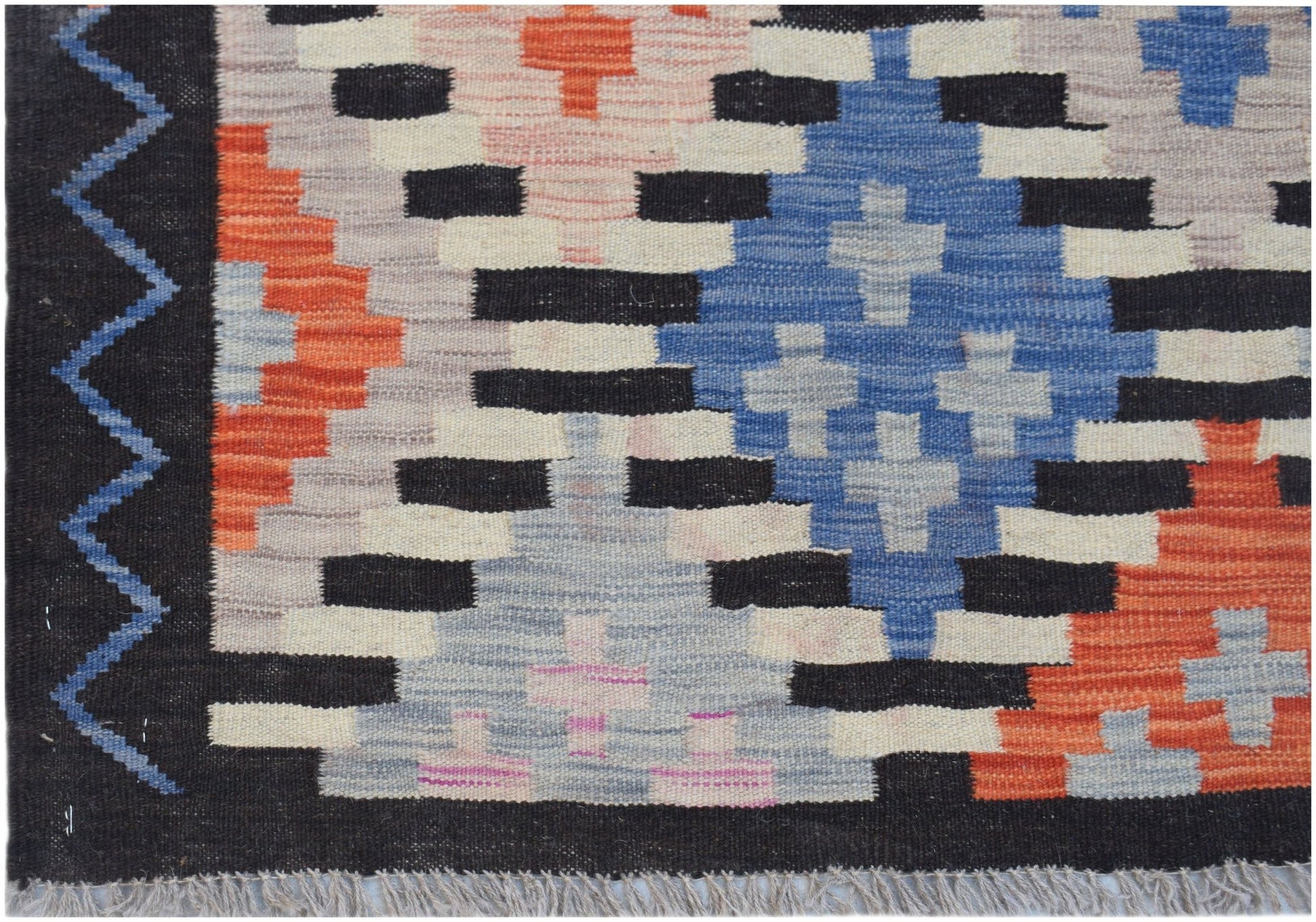 Handwoven Afghan Maimana kilim featuring a geometric pattern in blue, orange, and cream tones.
