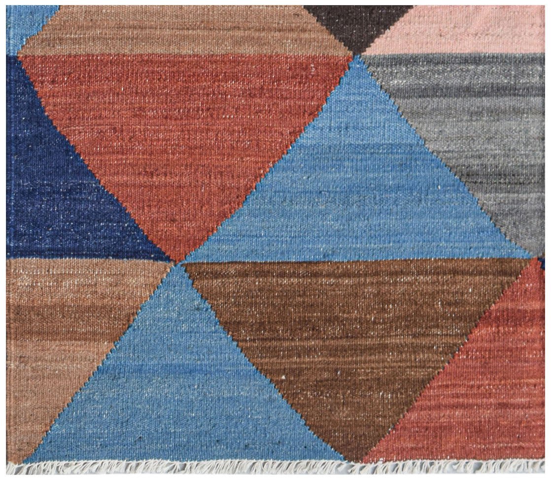 Handwoven Afghan Maimana wool kilim featuring a geometric pattern of multicolored triangles.