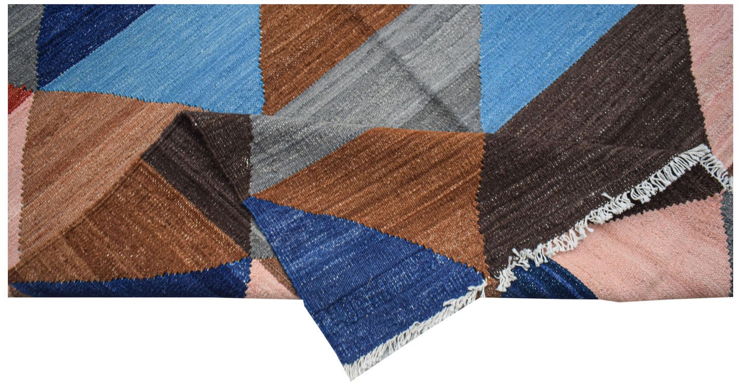 Handwoven Afghan Maimana kilim rug featuring a geometric pattern in blue, brown, grey, and pink.