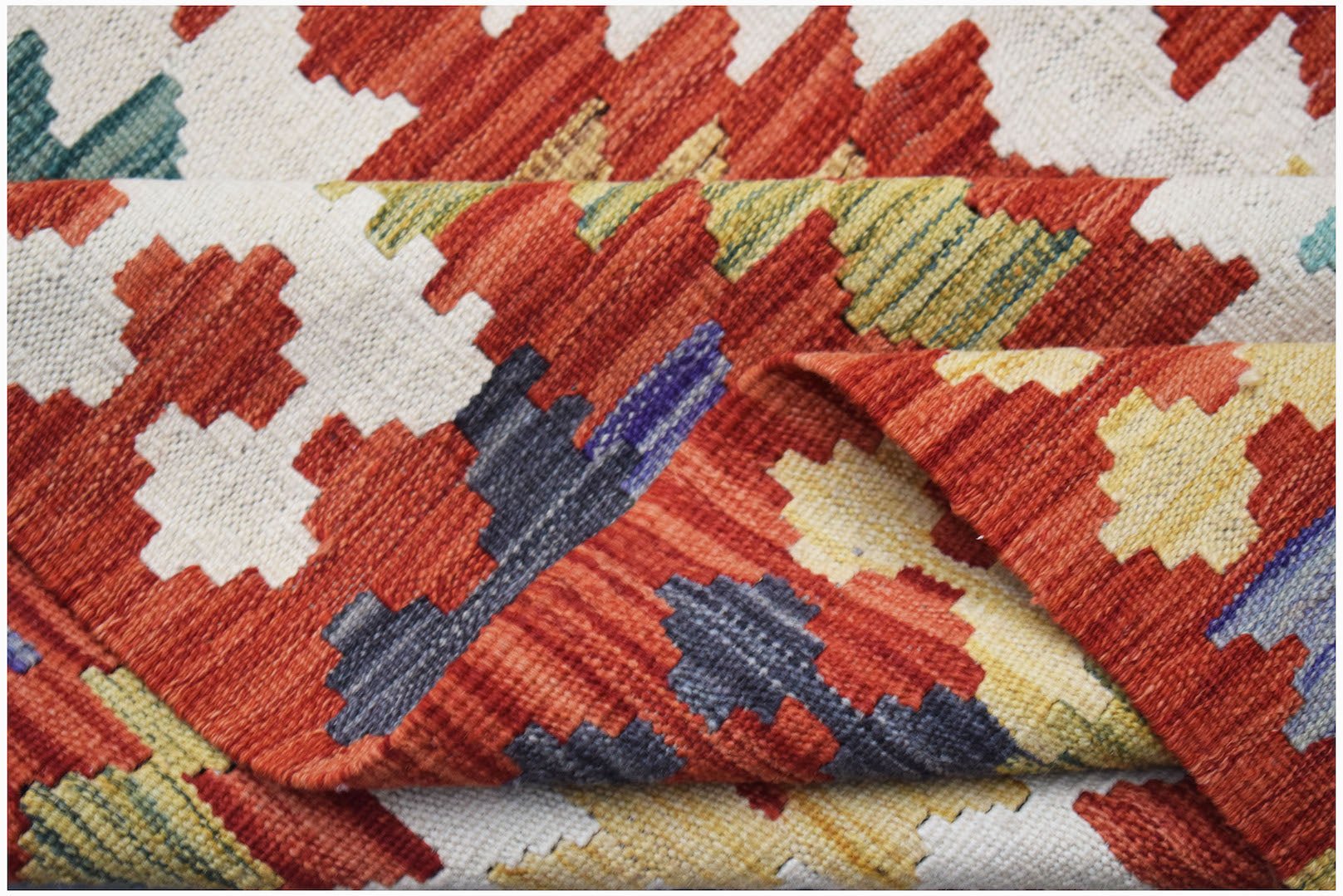Handwoven Afghan Maimana kilim rug featuring a geometric pattern in red, yellow, and blue tones.
