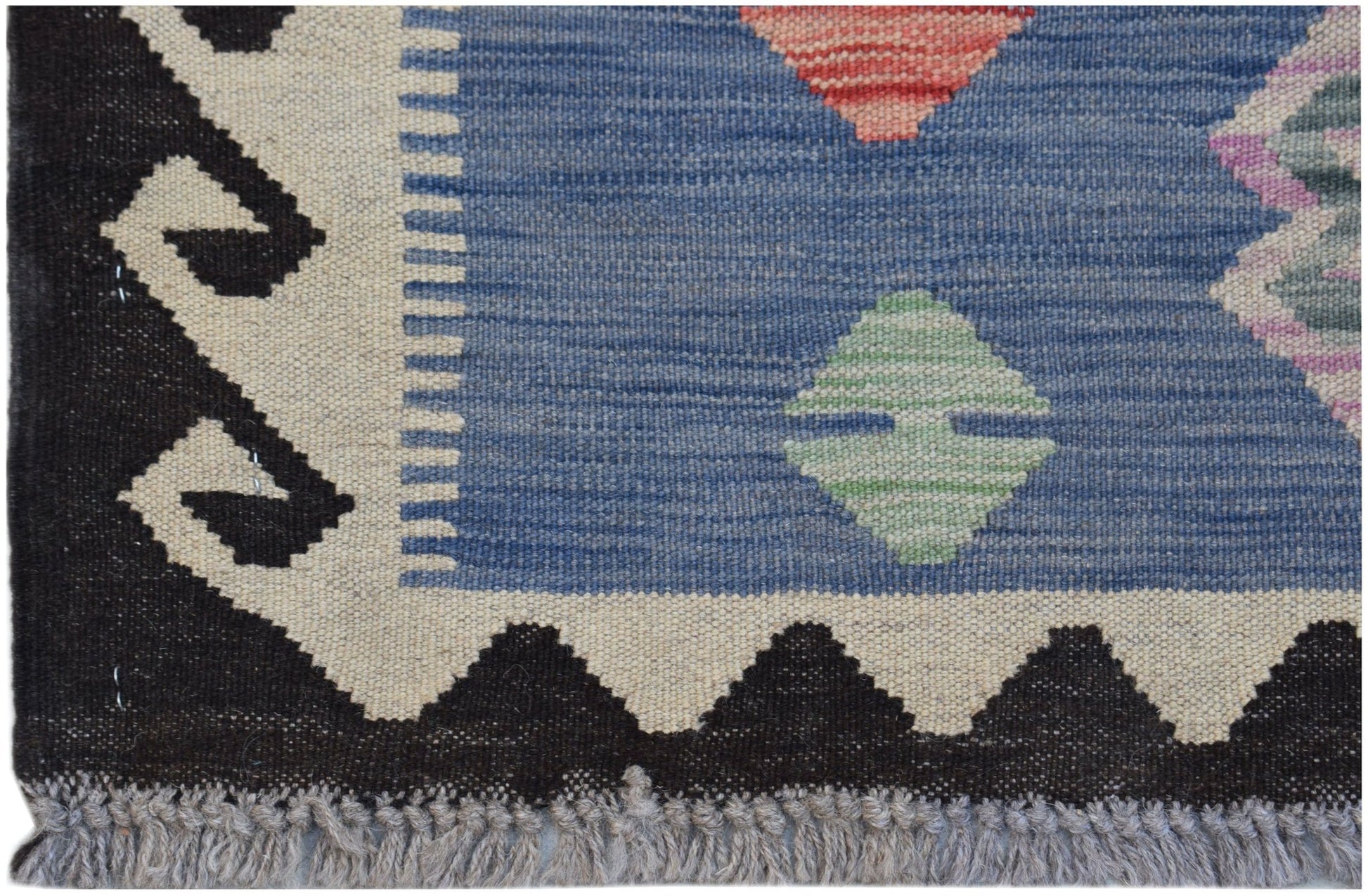 Handwoven Afghan Maimana kilim featuring a blue field with geometric patterns and a fringed edge.