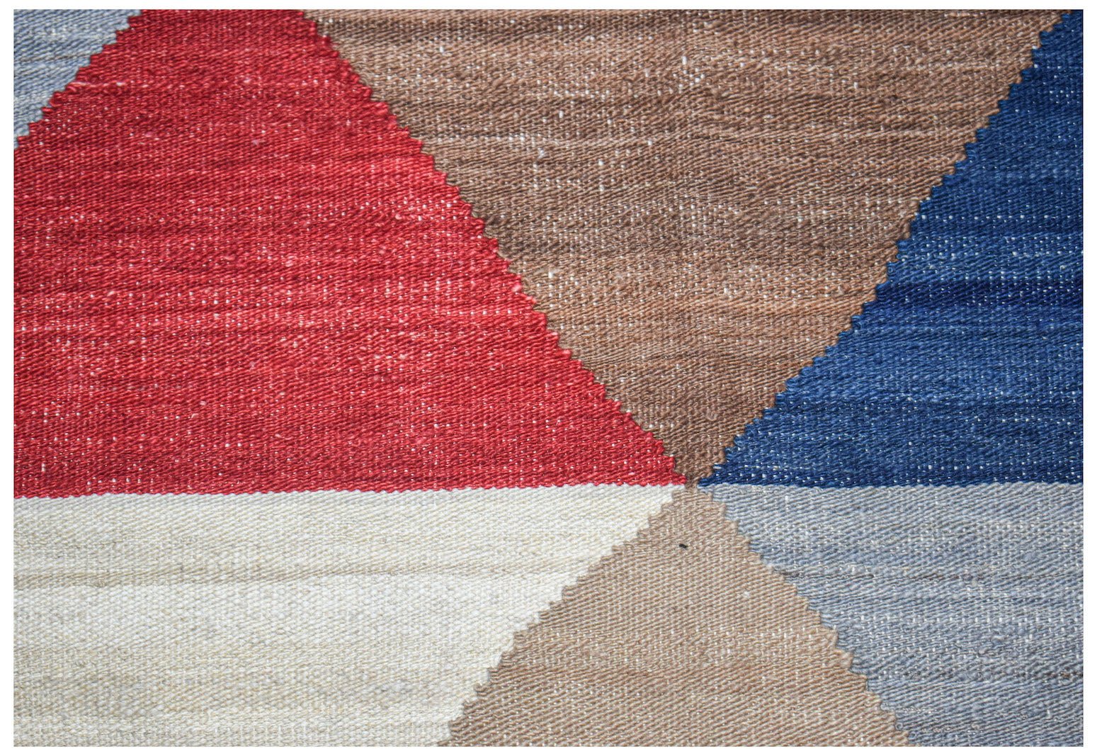 A handmade Afghan Maimana kilim featuring a geometric pattern in red, blue, brown, and cream.