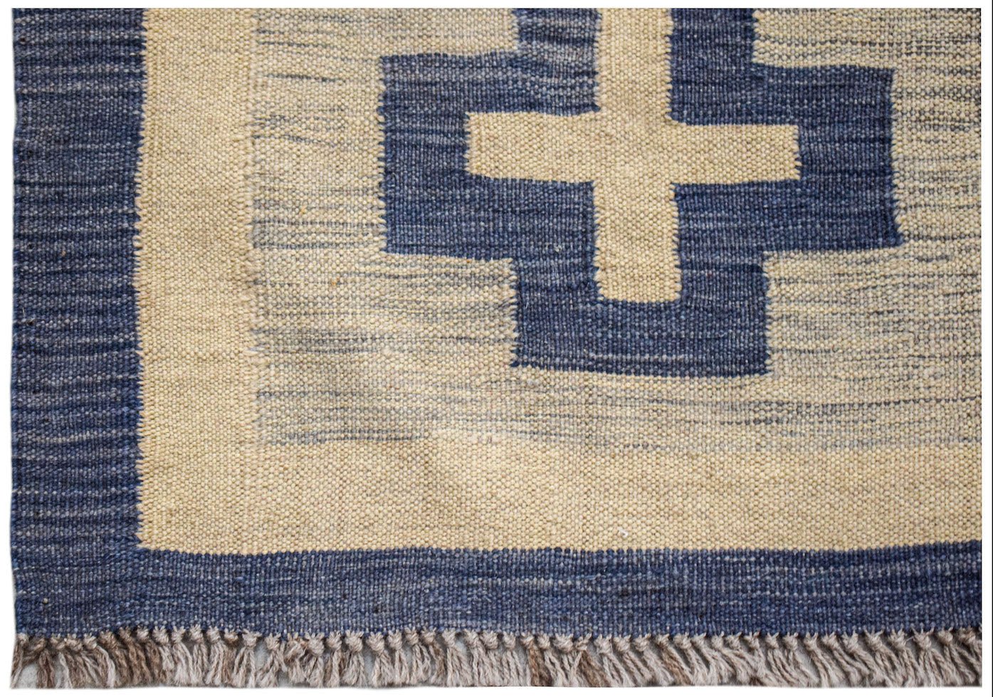 Handwoven Afghan Maimana kilim rug featuring a blue and cream geometric cross pattern.