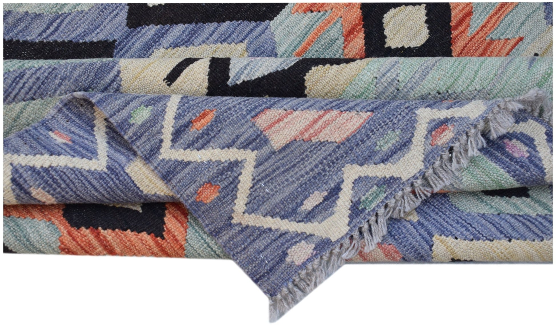 A handmade Afghan Maimana kilim rug featuring a geometric pattern in blue, orange, and cream wool.