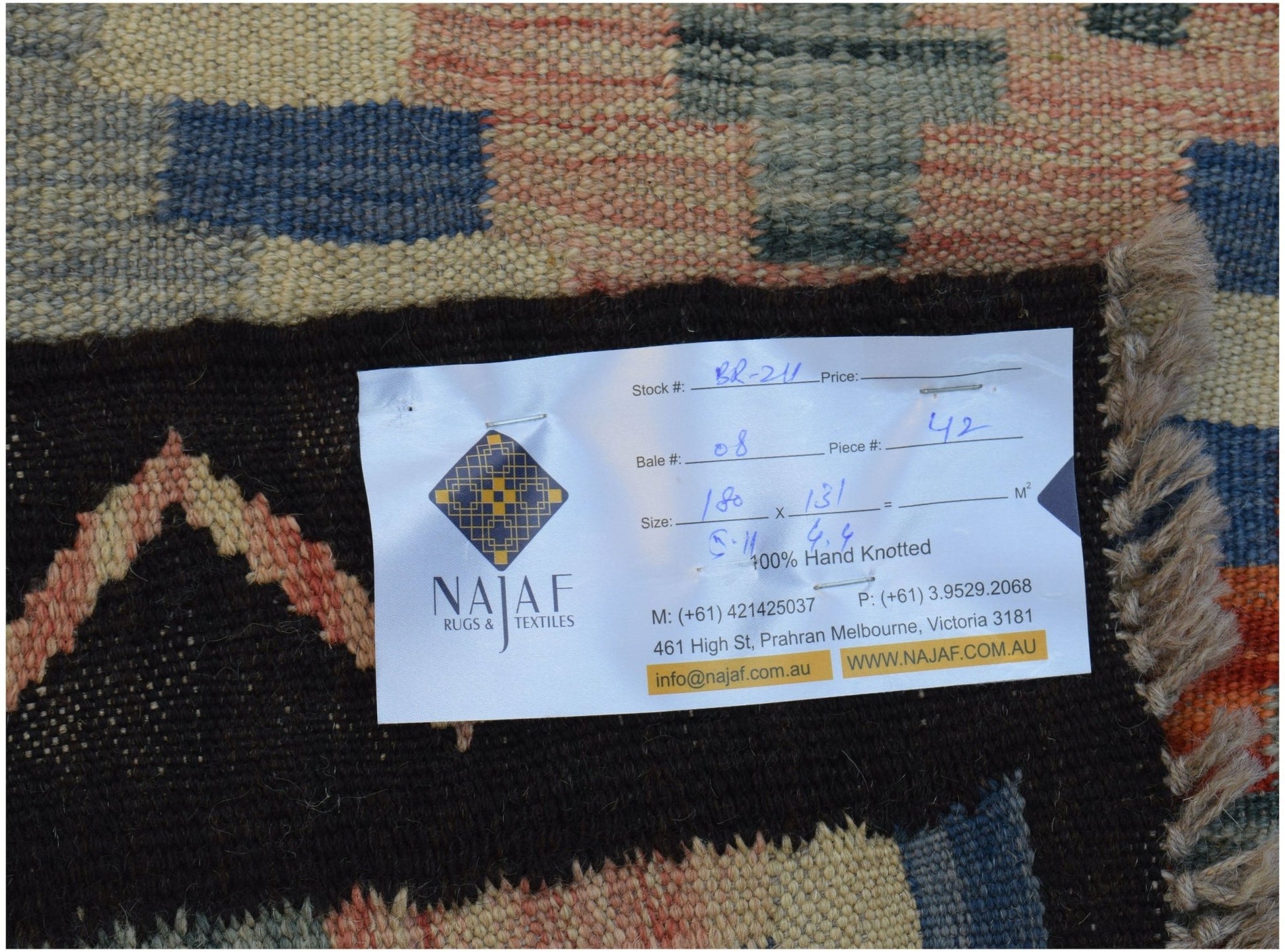 A handwoven Afghan Maimana kilim featuring a geometric pattern in blue, orange, and cream tones.