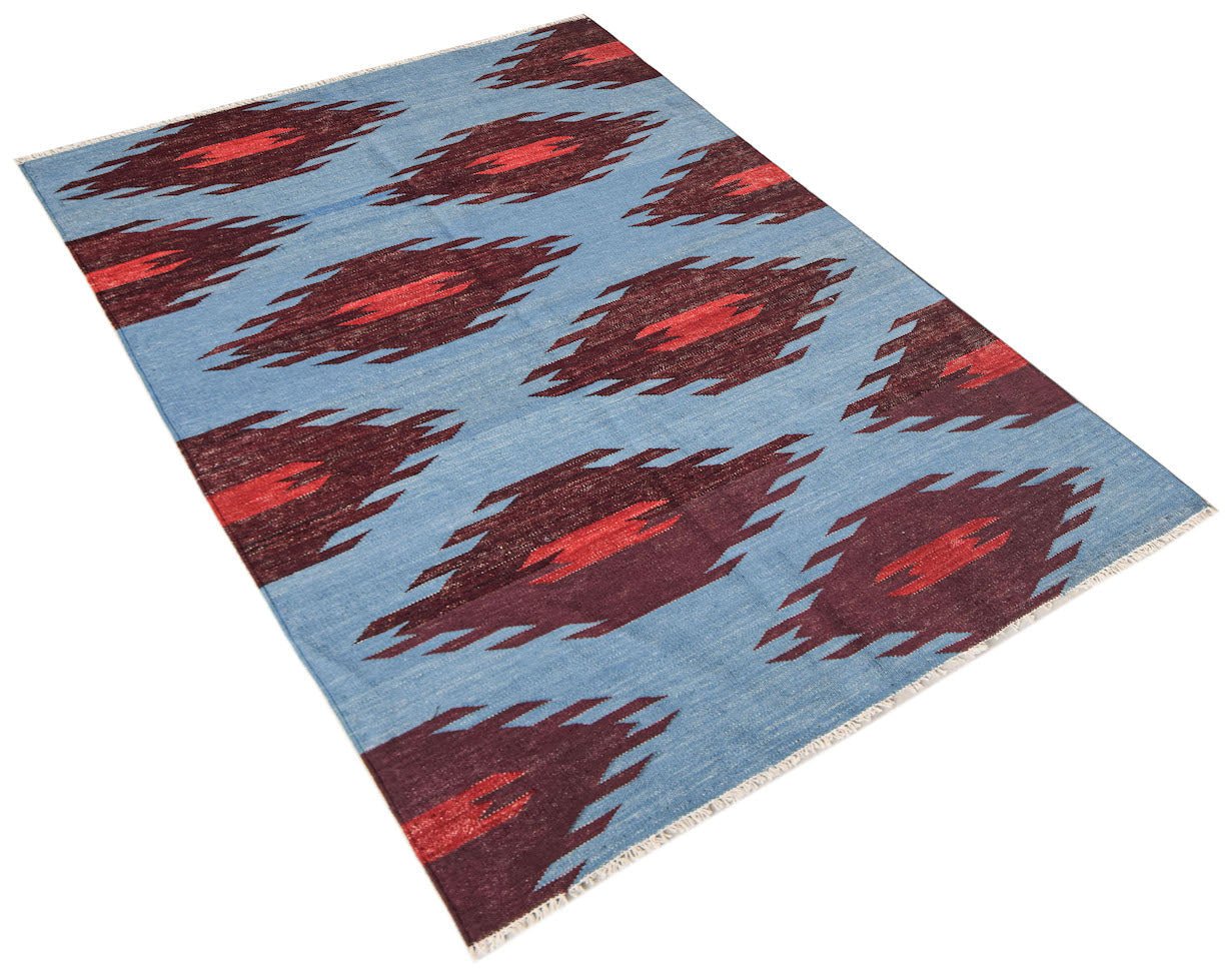 Afghan Maimana Kilim with a blue background and repeating red and dark red diamond patterns.