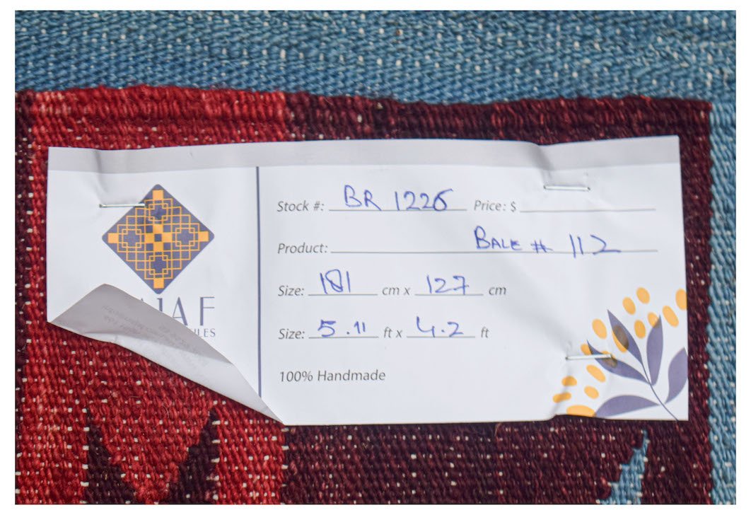 Afghan Maimana Kilim with a tag showing size and stock number.