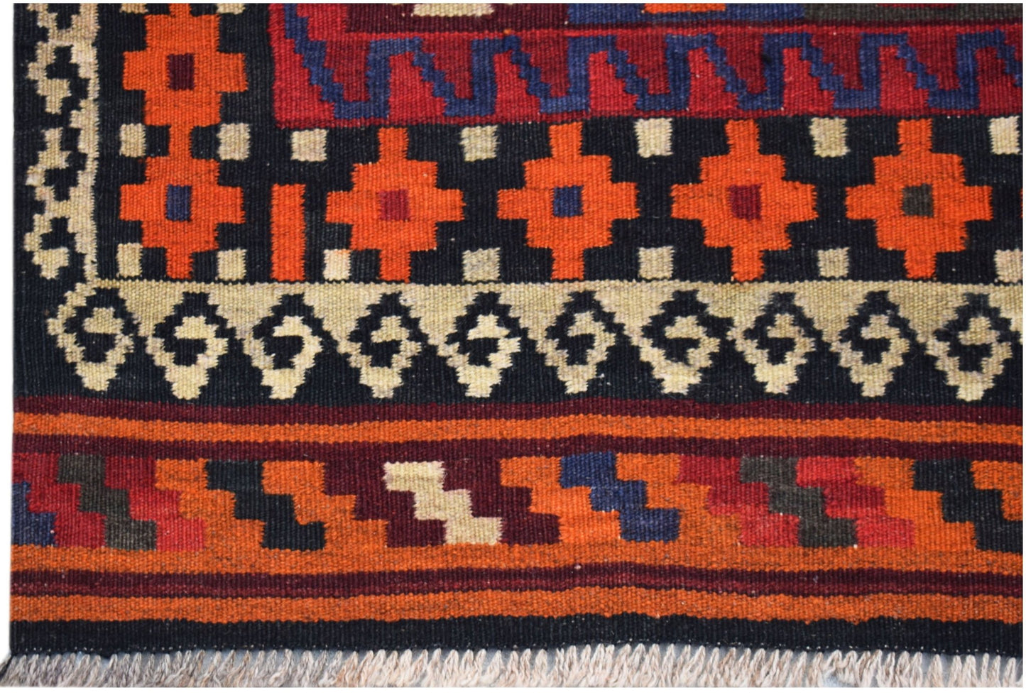 Handwoven Afghan Maimana kilim featuring geometric patterns in orange, red, and blue wool.