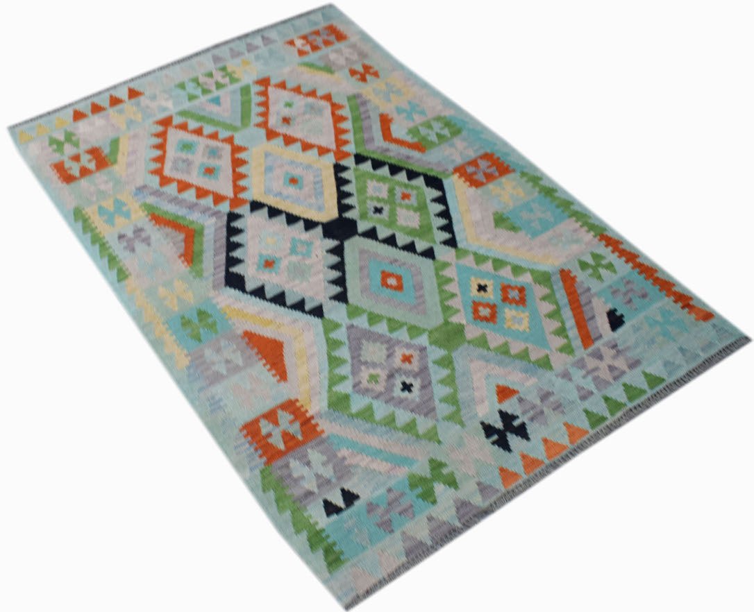Handwoven Afghan Maimana kilim rug featuring a colorful geometric diamond pattern on a blue base.