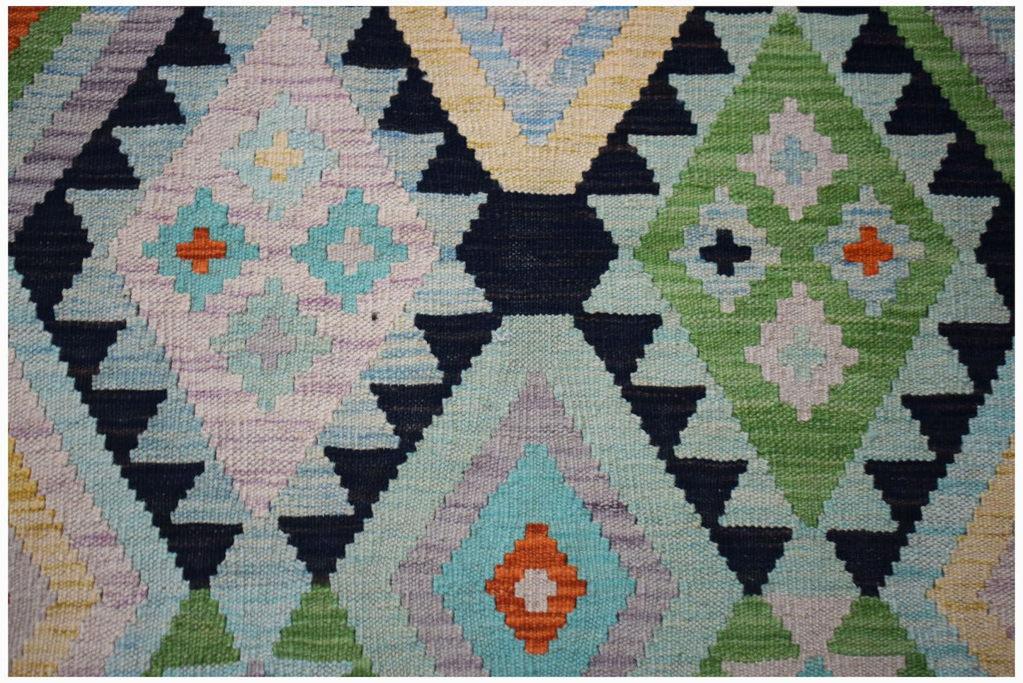 Handwoven Afghan Maimana wool kilim featuring a colorful geometric diamond pattern.