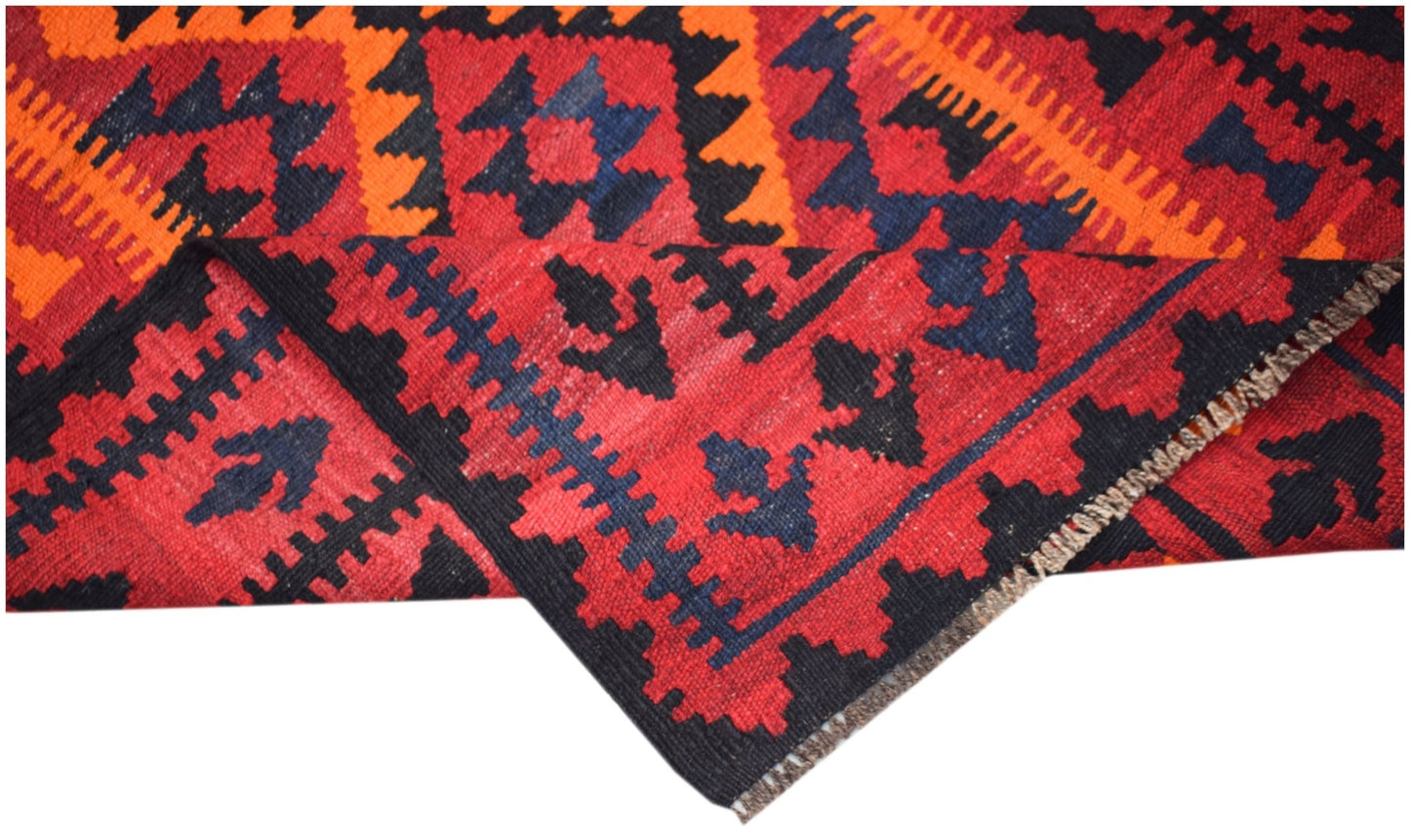 A handmade Afghan Maimana kilim featuring a geometric pattern in red, black, and orange wool.