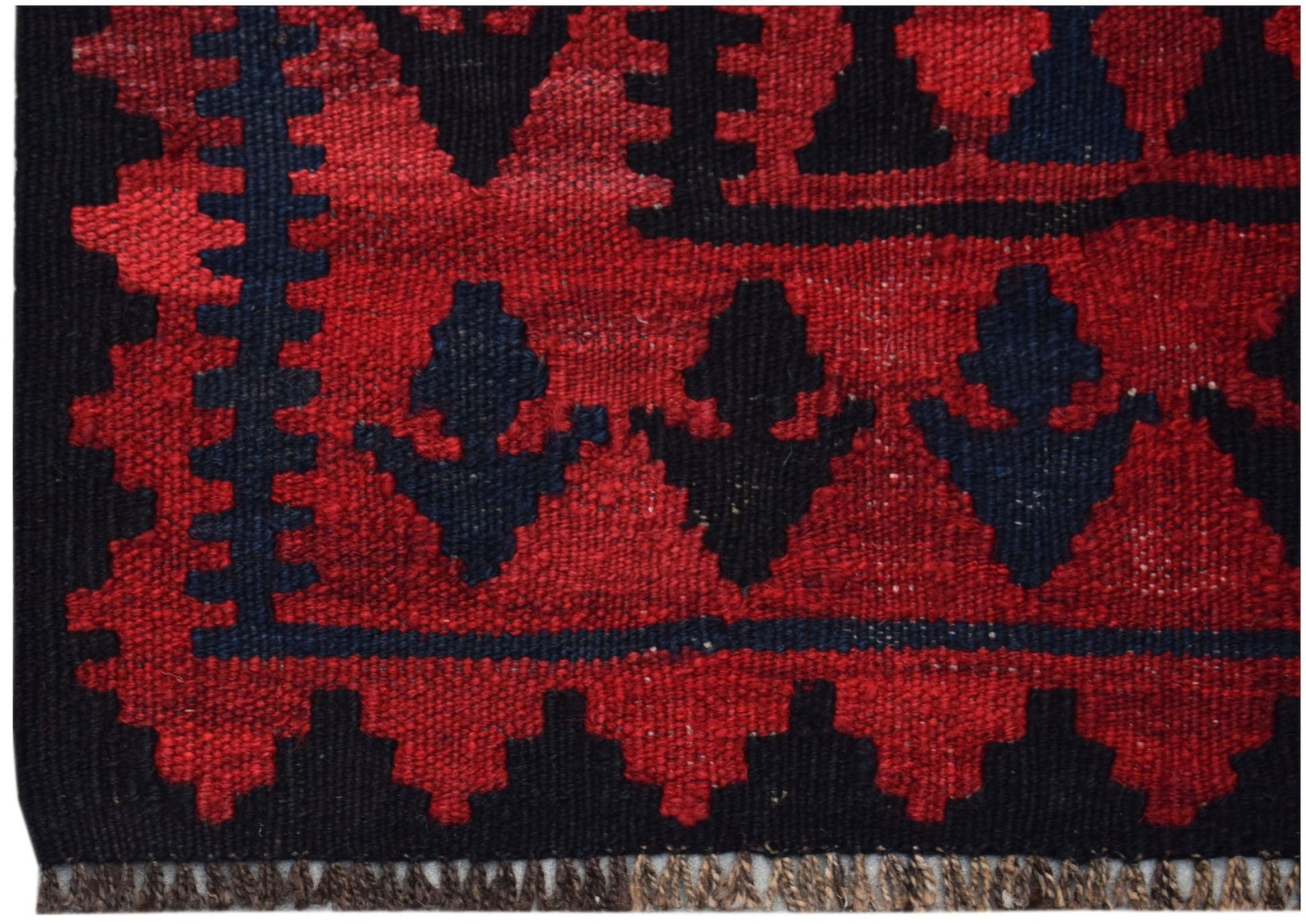 Handwoven Afghan Maimana kilim featuring a geometric pattern in deep red and black wool.