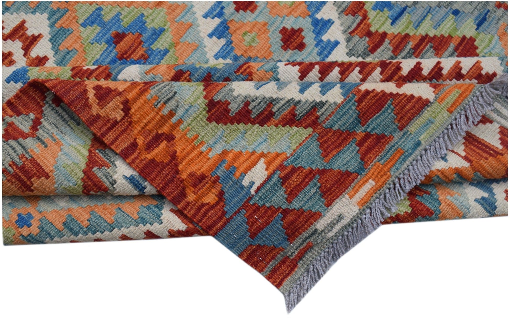 A handwoven Afghan Maimana kilim rug featuring a geometric pattern in orange, blue, and green.