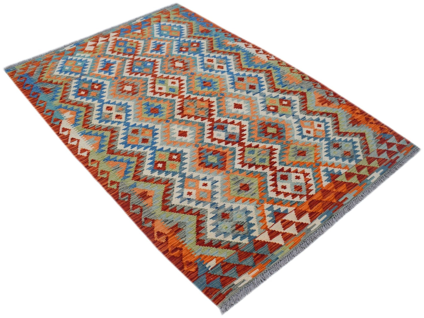 A handmade Afghan Maimana kilim rug featuring a vibrant geometric pattern in wool.