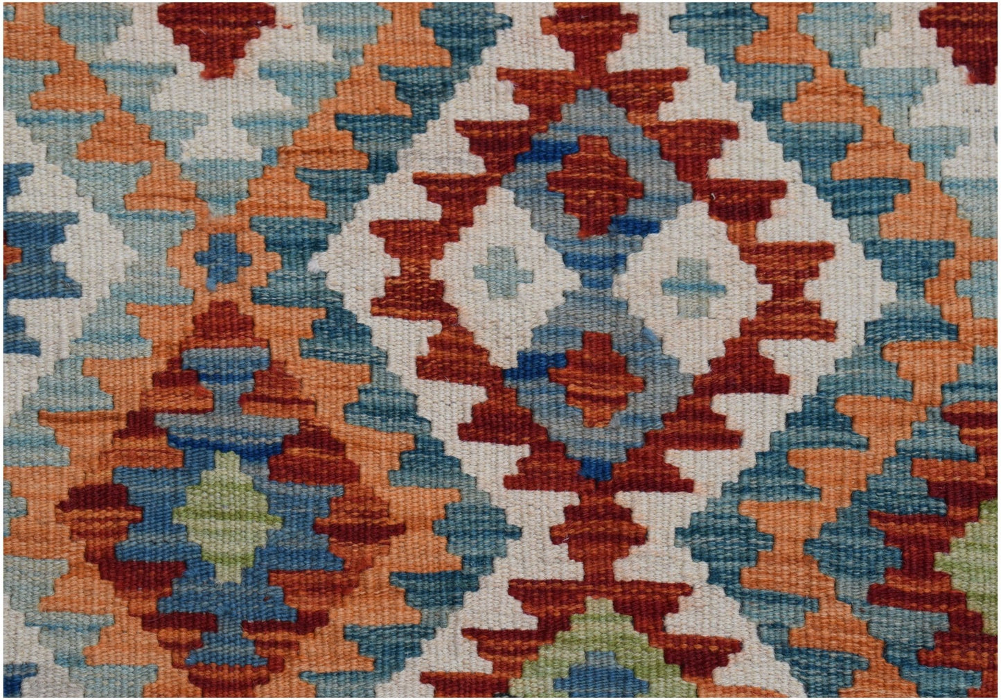 A handwoven Afghan Maimana kilim featuring a geometric pattern in red, blue, orange, and cream.