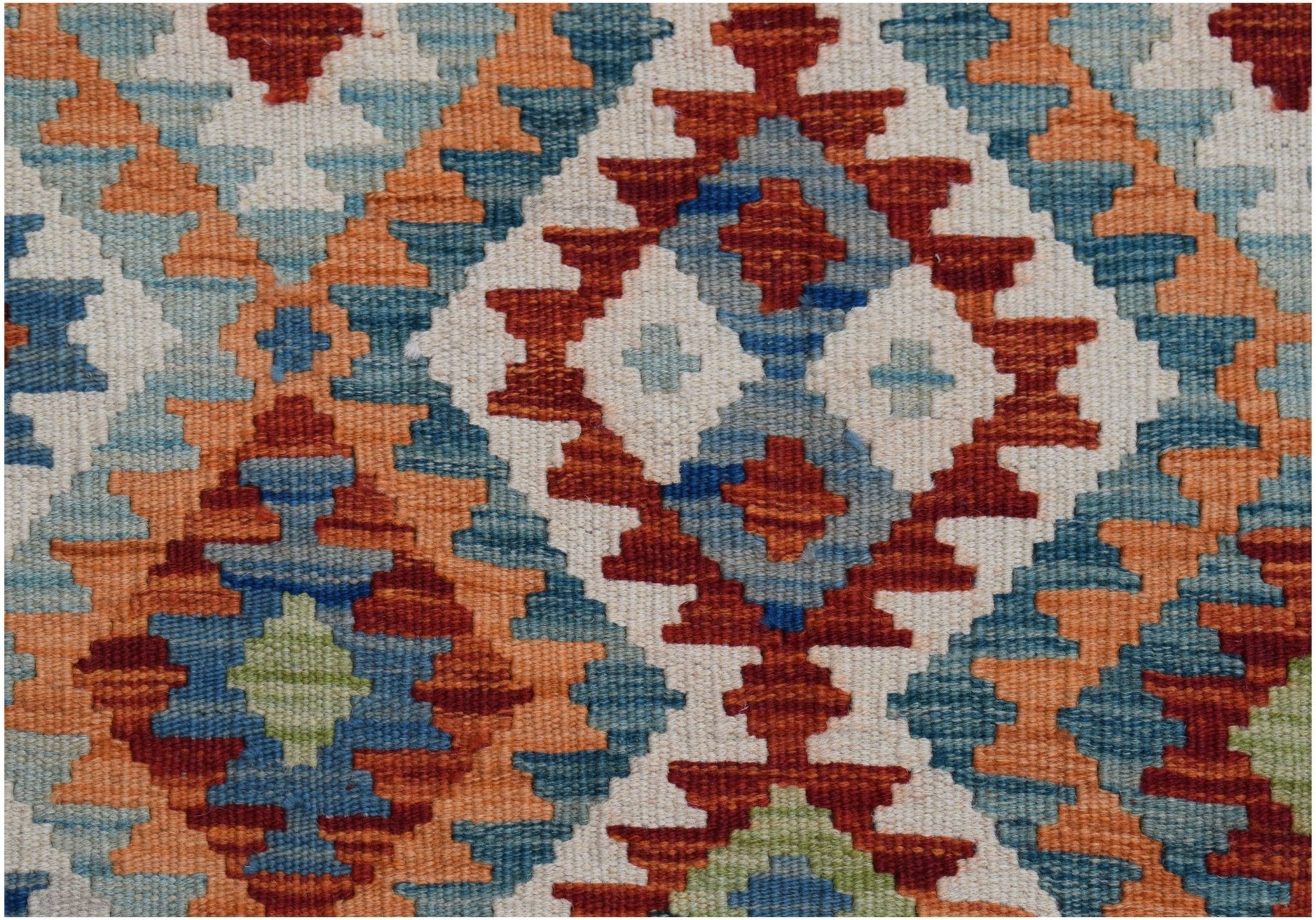 A handwoven Afghan Maimana kilim featuring a geometric pattern in red, blue, orange, and cream.