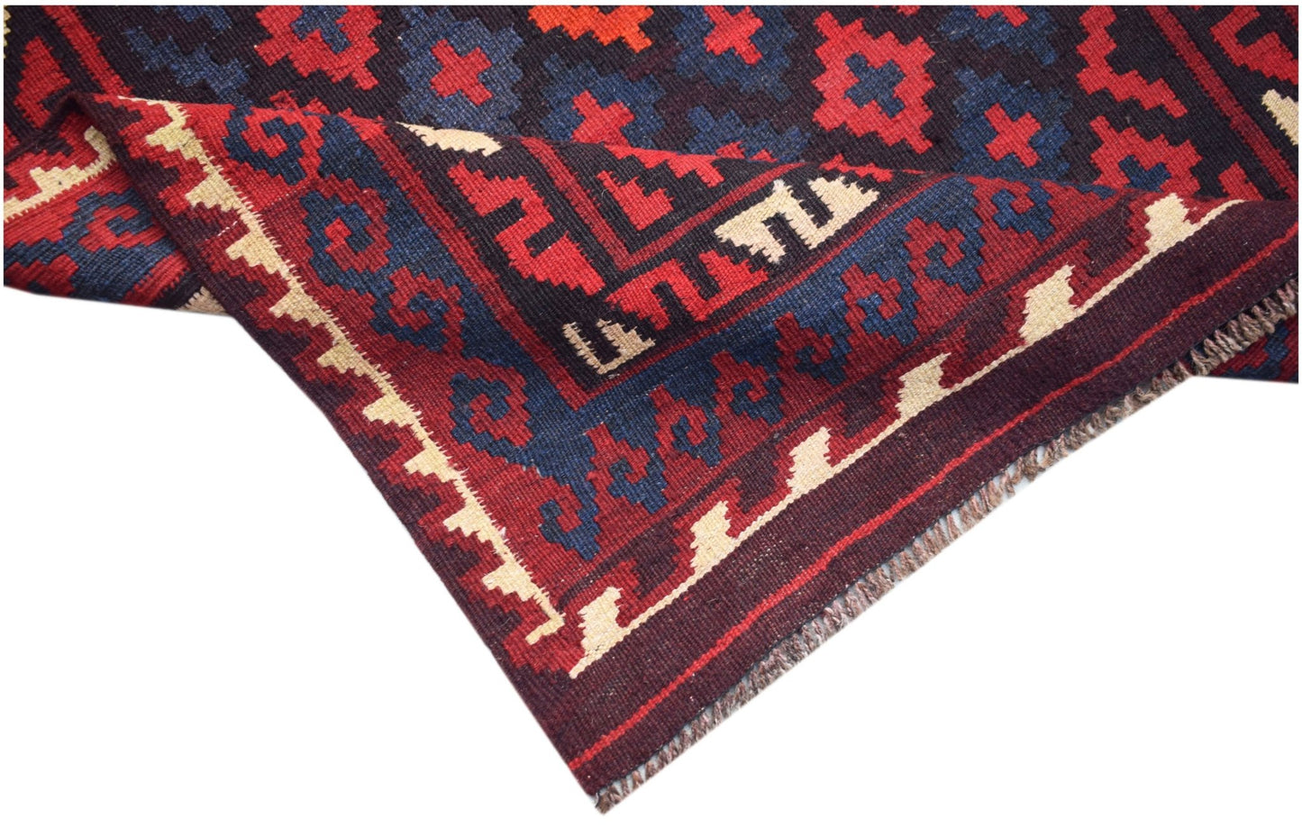 A handmade Afghan Maimana kilim rug featuring geometric patterns in red, blue, and cream wool.