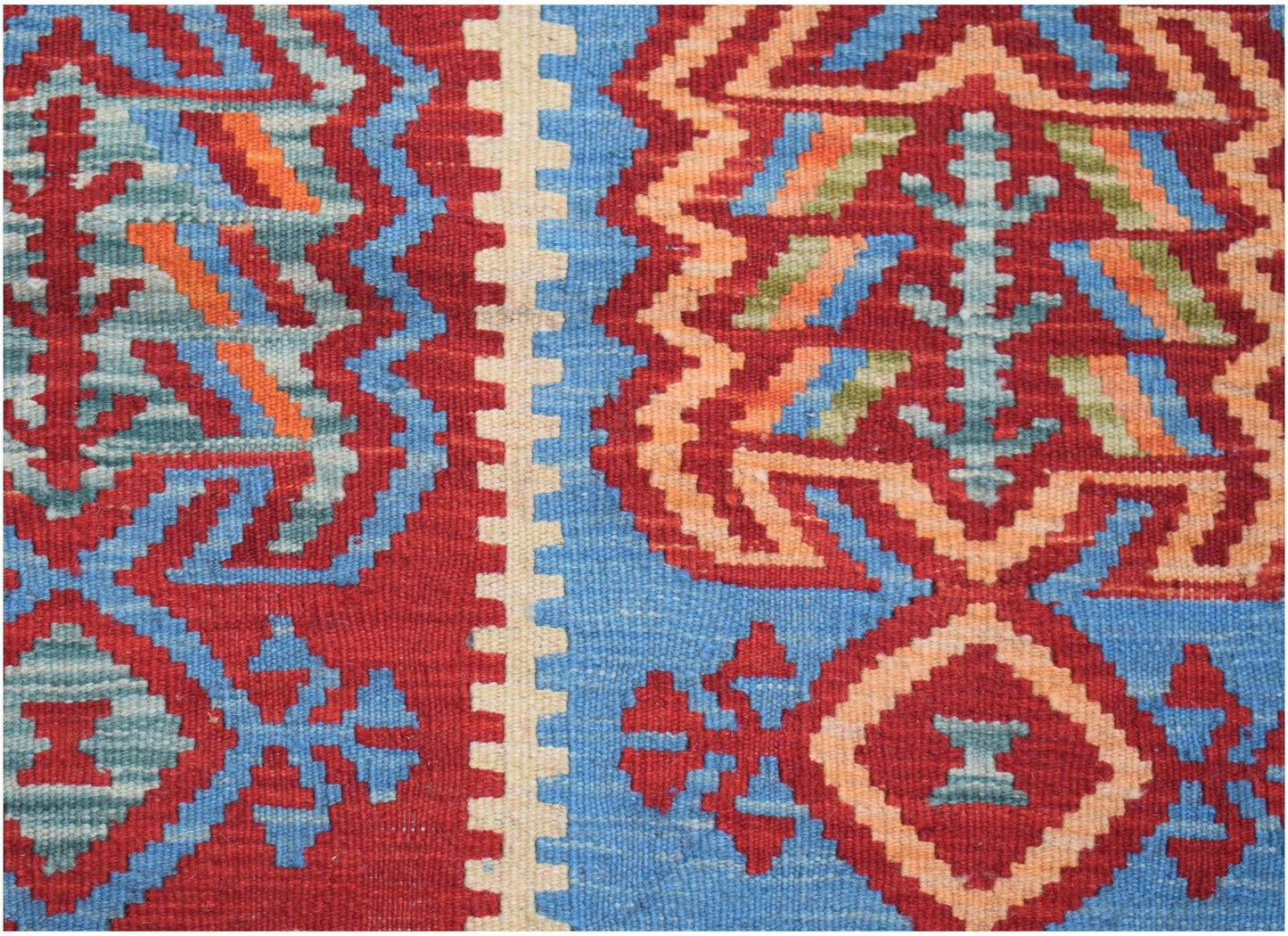 Handwoven Afghan Maimana kilim featuring geometric patterns in red, blue, and orange wool.