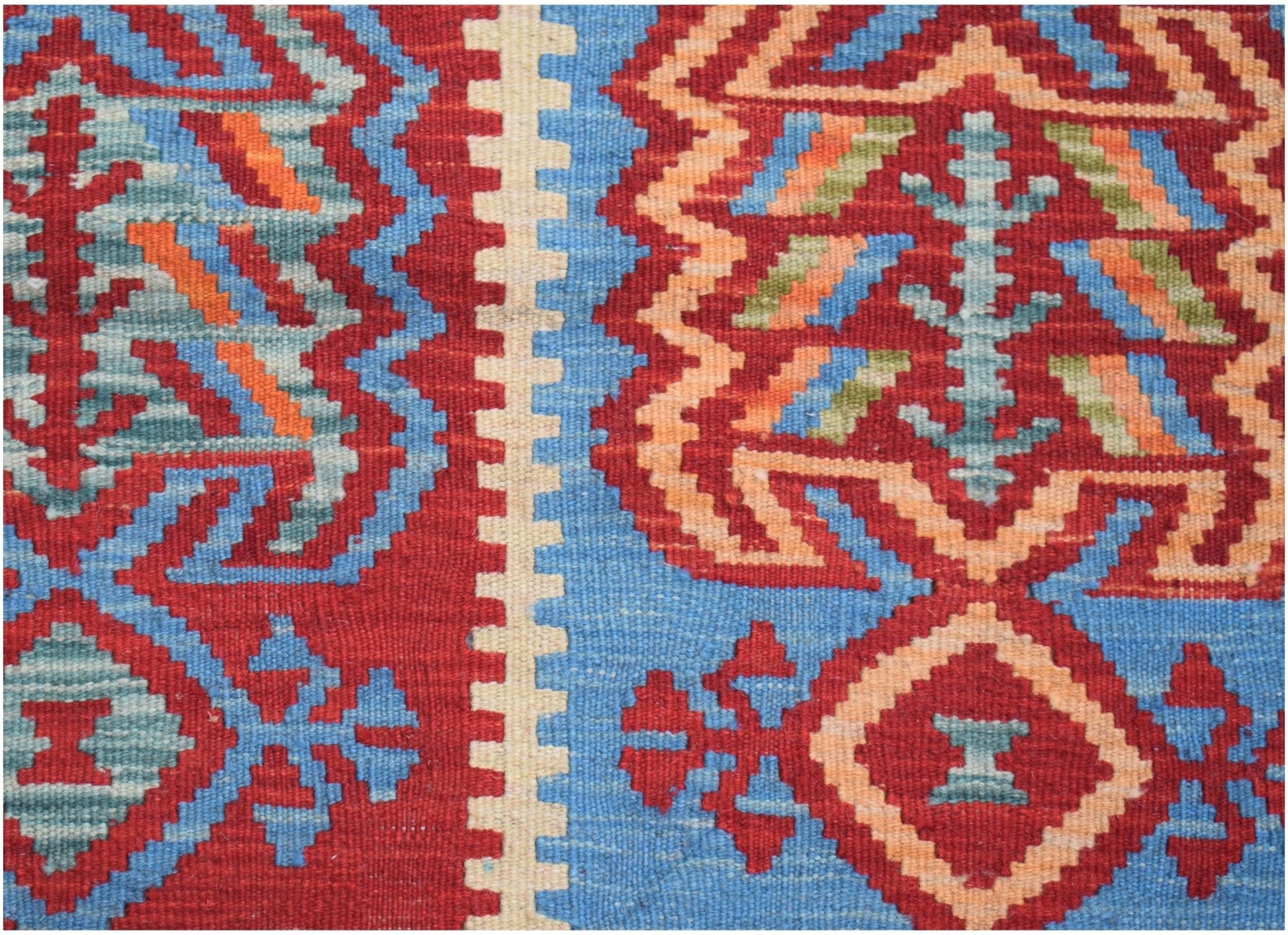 Handwoven Afghan Maimana kilim featuring geometric patterns in red, blue, and orange wool.