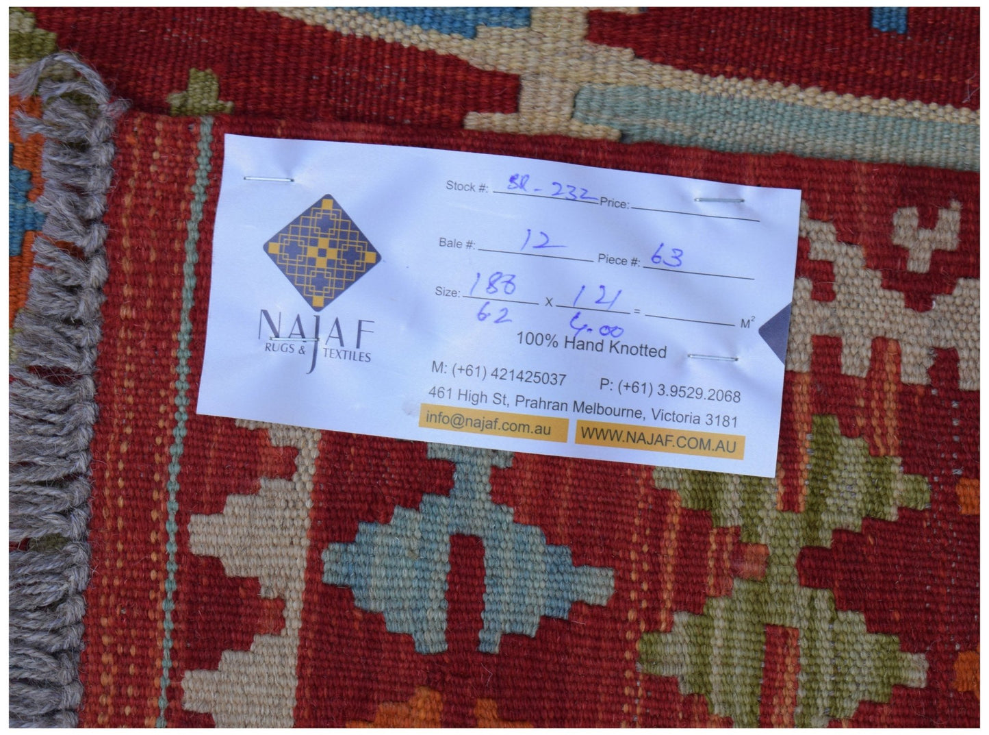 A handwoven Afghan Maimana kilim featuring a geometric pattern in red, blue, and beige tones.