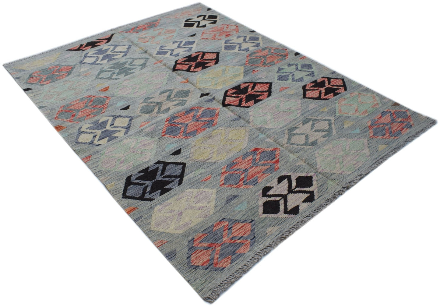 Handwoven Afghan Maimana kilim rug featuring a geometric pattern in muted tones on a grey field.