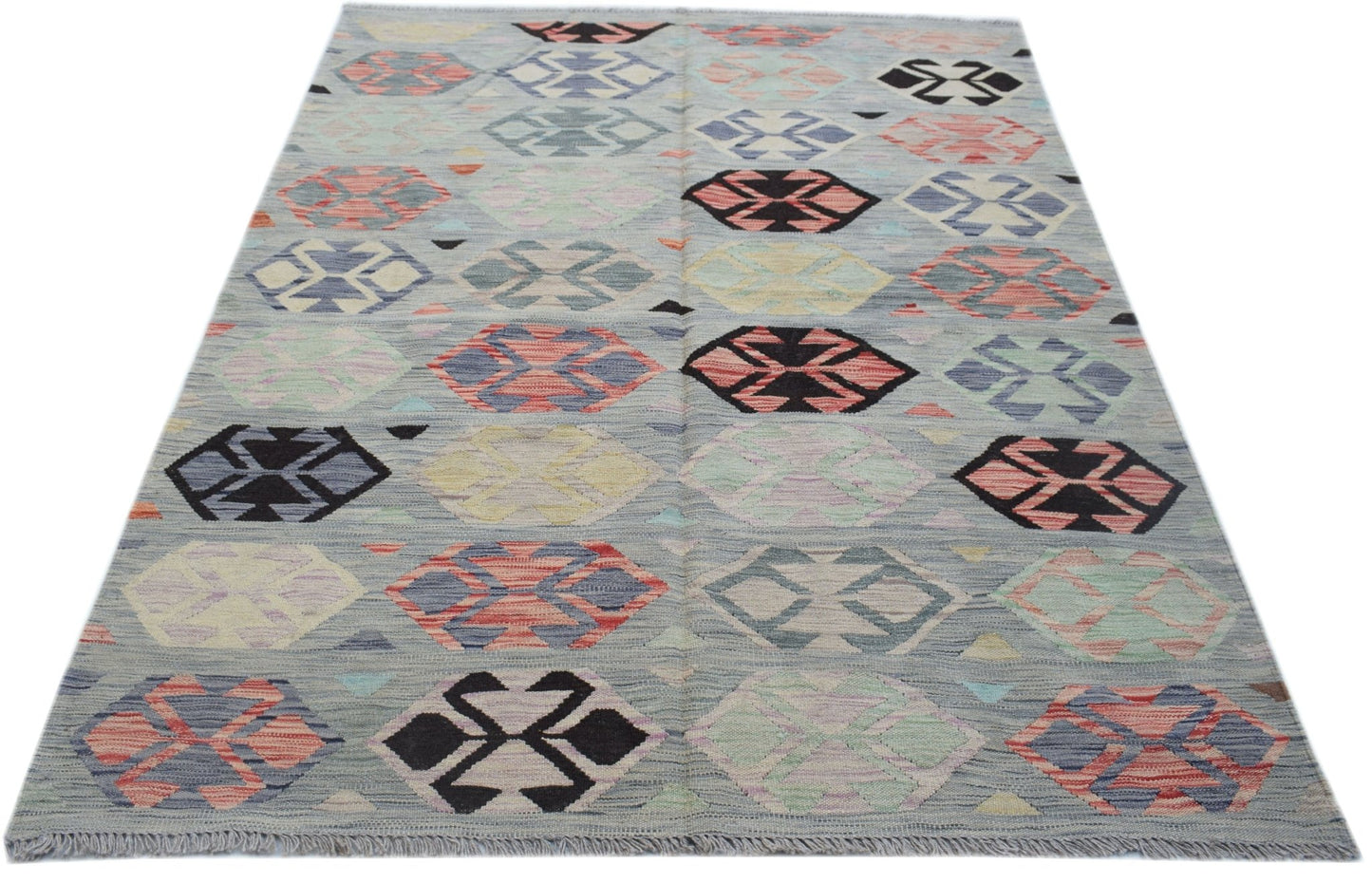 Handwoven Afghan Maimana kilim rug featuring a geometric pattern in multicolored wool.