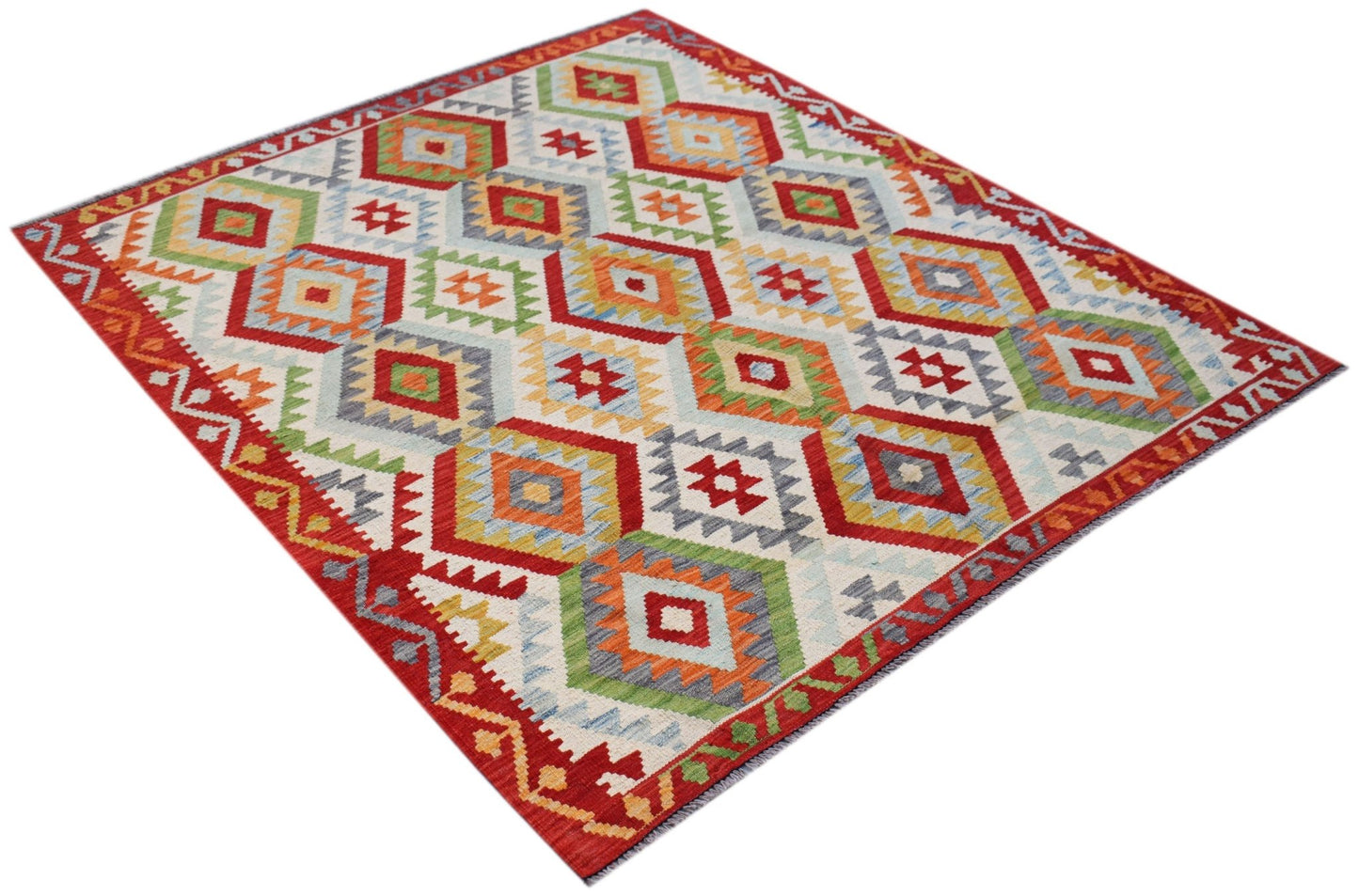 Handwoven Afghan Maimana kilim rug featuring a colorful geometric diamond pattern in wool.