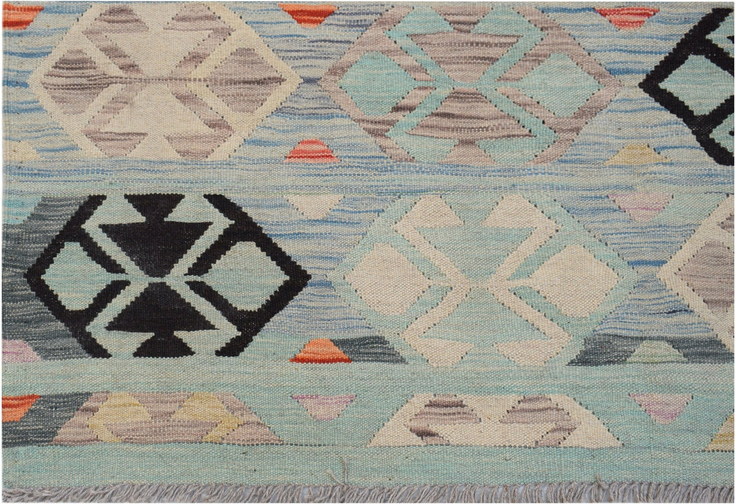 Handwoven Afghan Maimana kilim rug featuring a geometric pattern in blue, cream, and black tones.