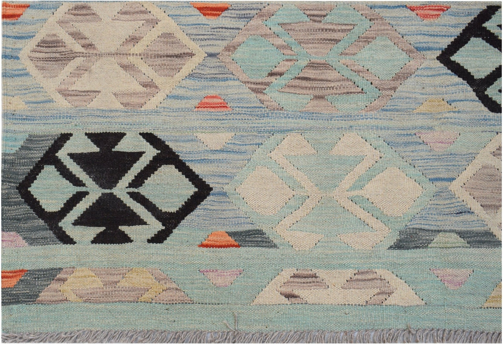 Handwoven Afghan Maimana kilim rug featuring a geometric pattern in blue, cream, and black tones.
