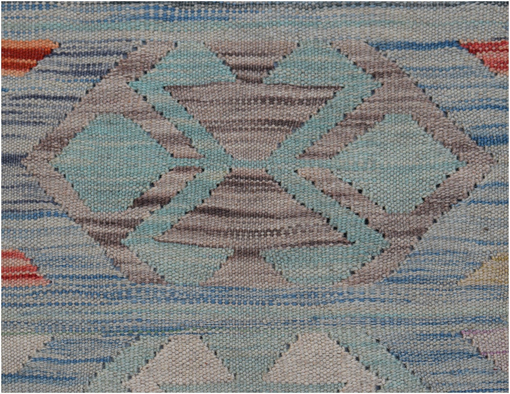 A handwoven Afghan Maimana kilim featuring a geometric pattern in blue, grey, and orange tones.