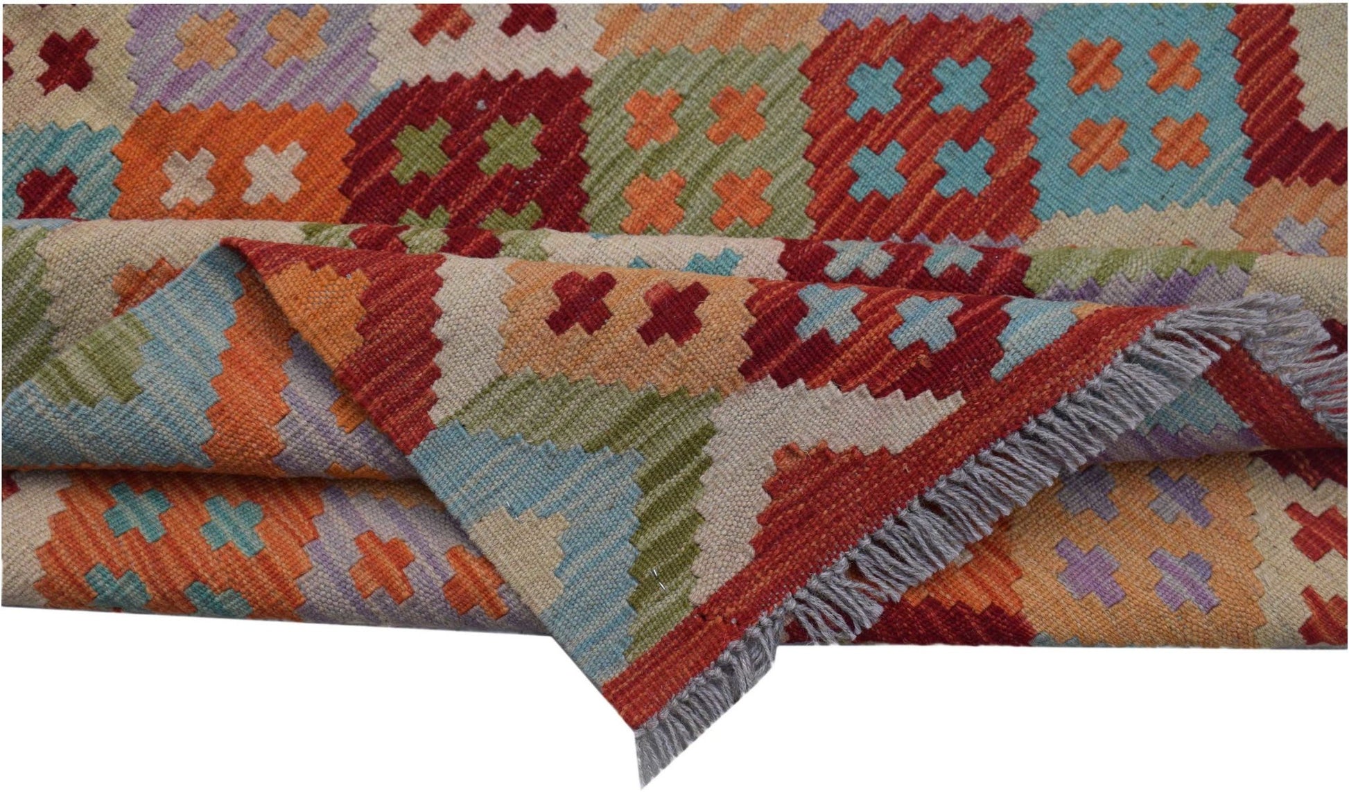 A handmade Afghan Maimana kilim rug featuring a colorful geometric pattern and fringed edges.