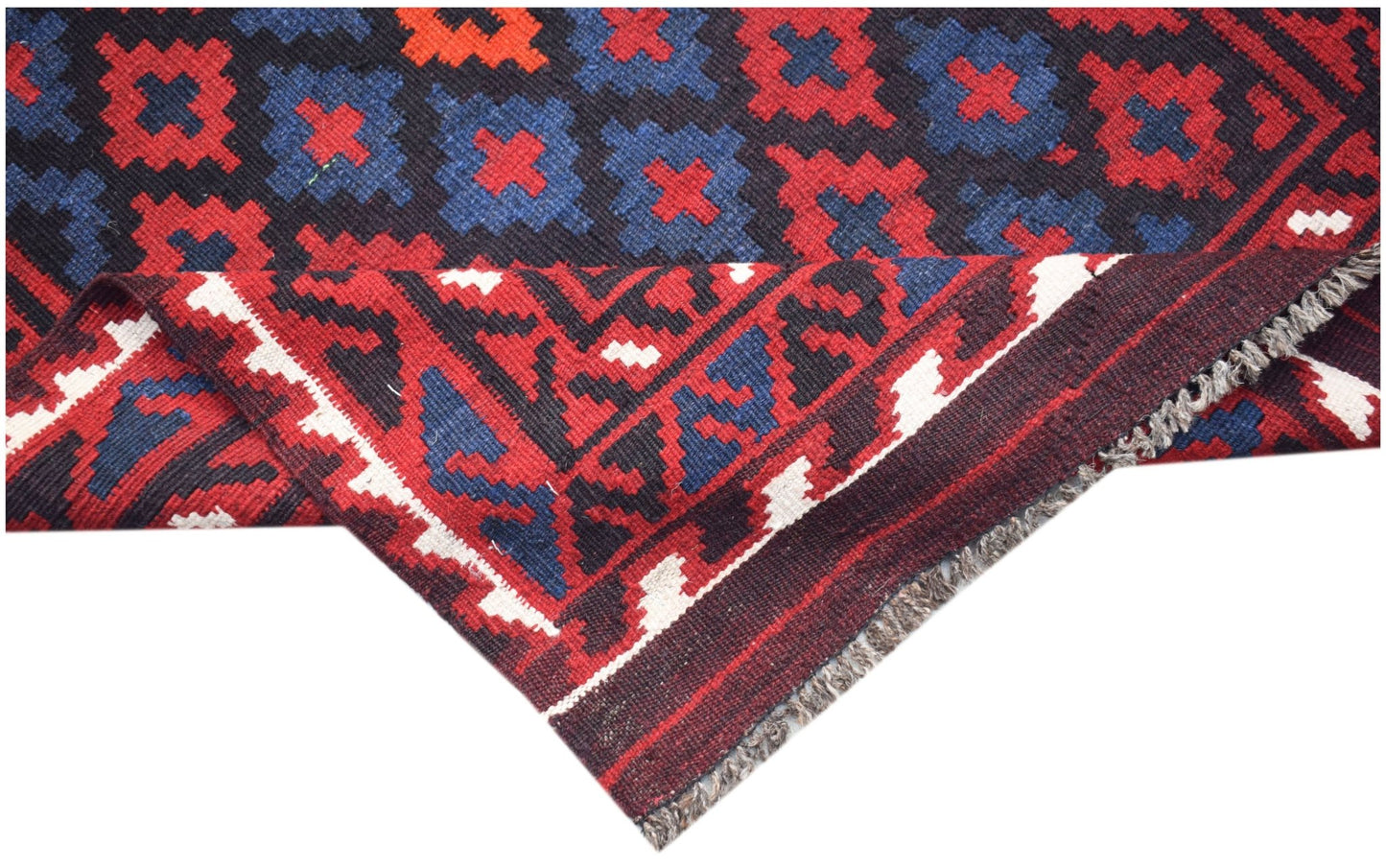 A handmade Afghan Maimana kilim featuring a geometric pattern in red, blue, and black wool.